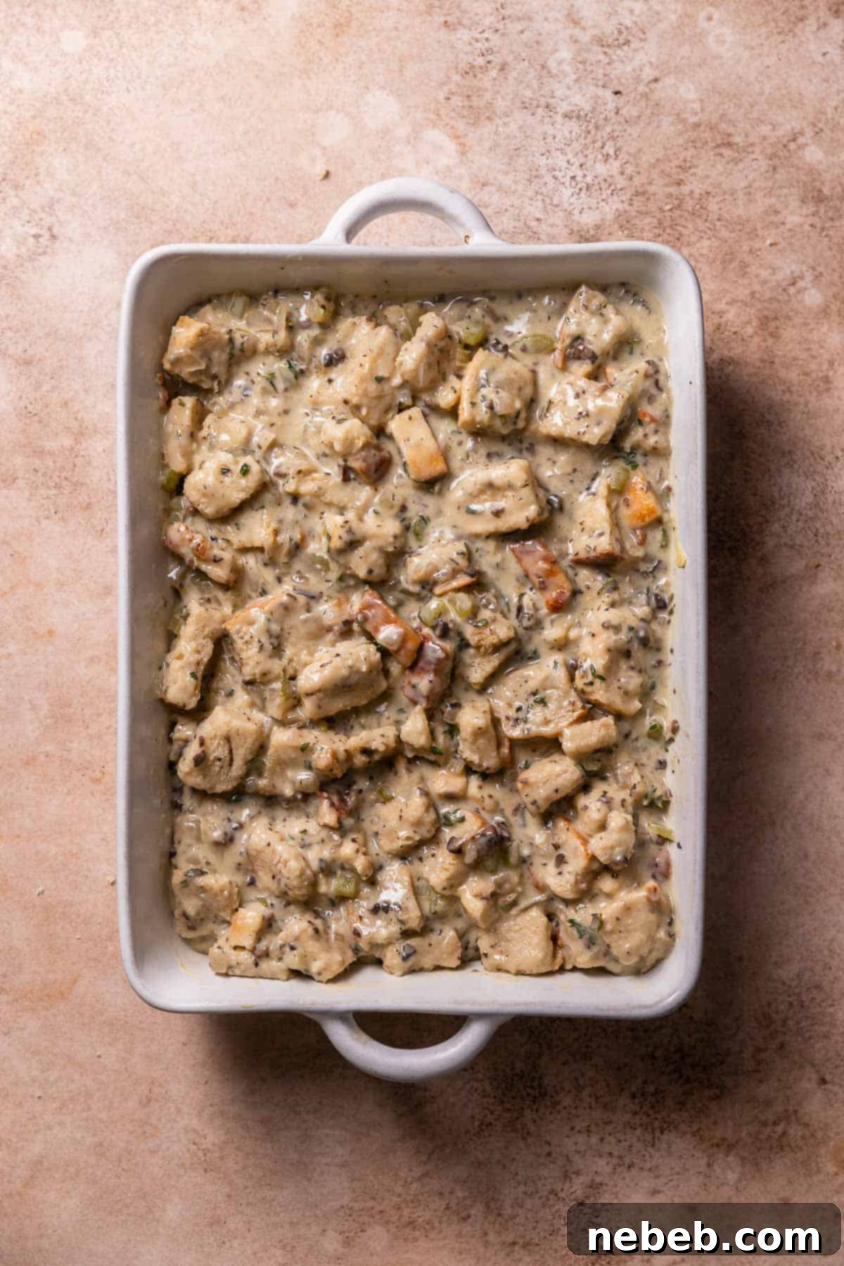 The savory bread pudding in a baking pan before baking.