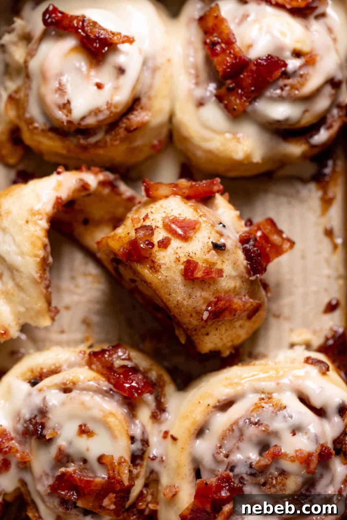a cinnamon roll unrolled to show the bacon and cinnamon sugar filling.