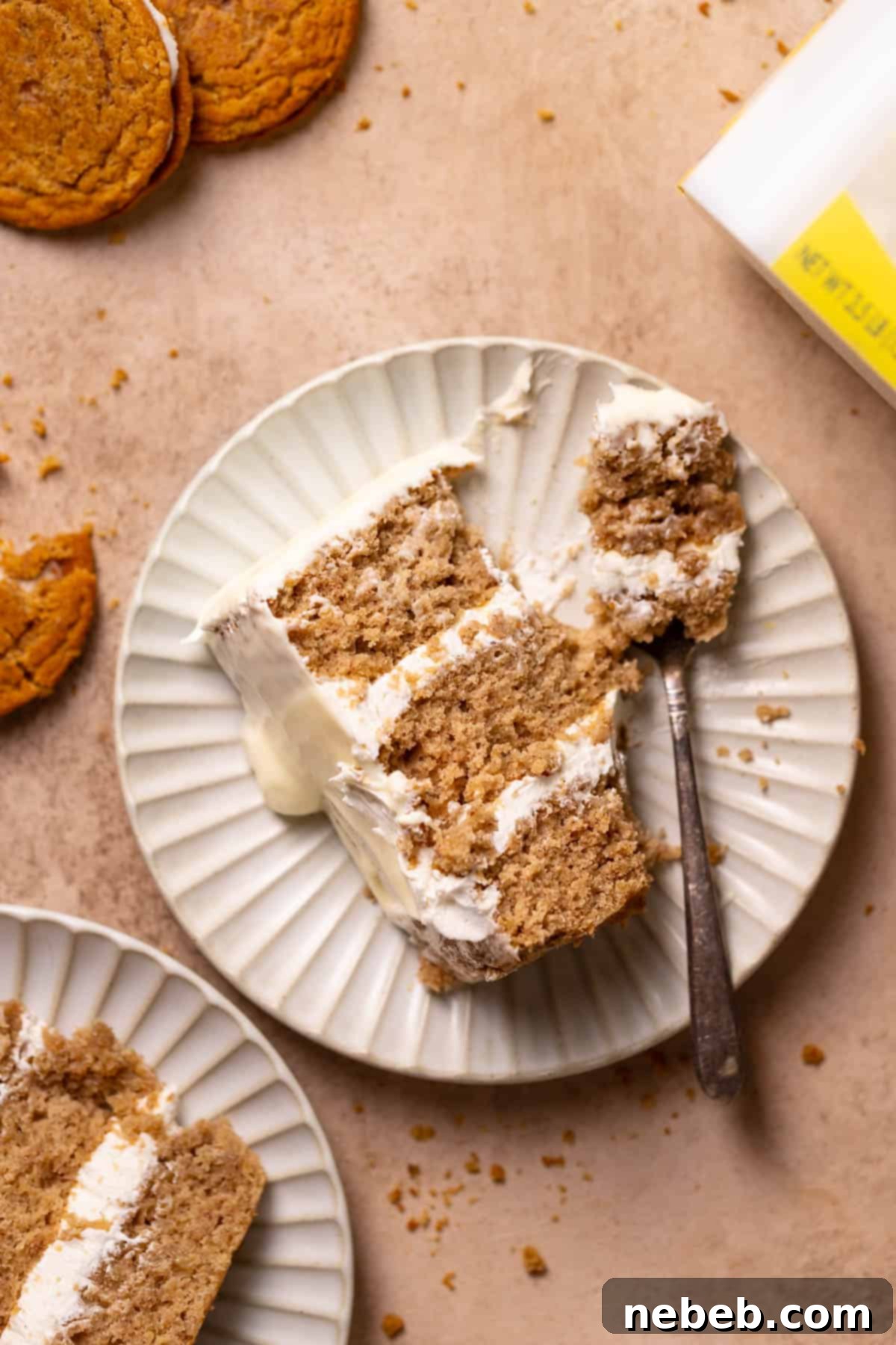 Oatmeal Cream Dream Cake 2 a slice of oatmeal cream pie cake on a plate with a fork cutting into it.