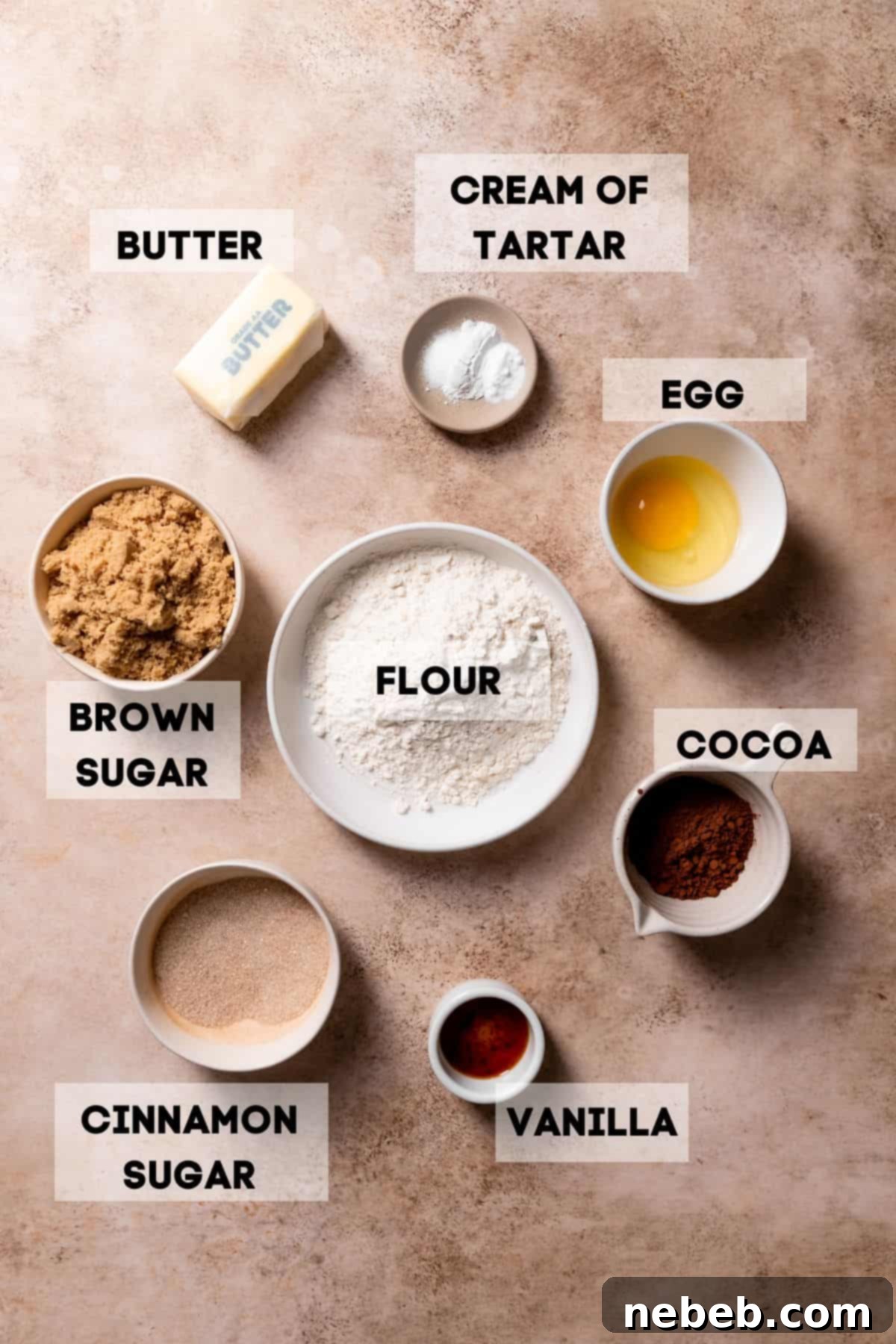 Bowls of ingredients needed to make chocolate cookies, clearly labeled for baking.