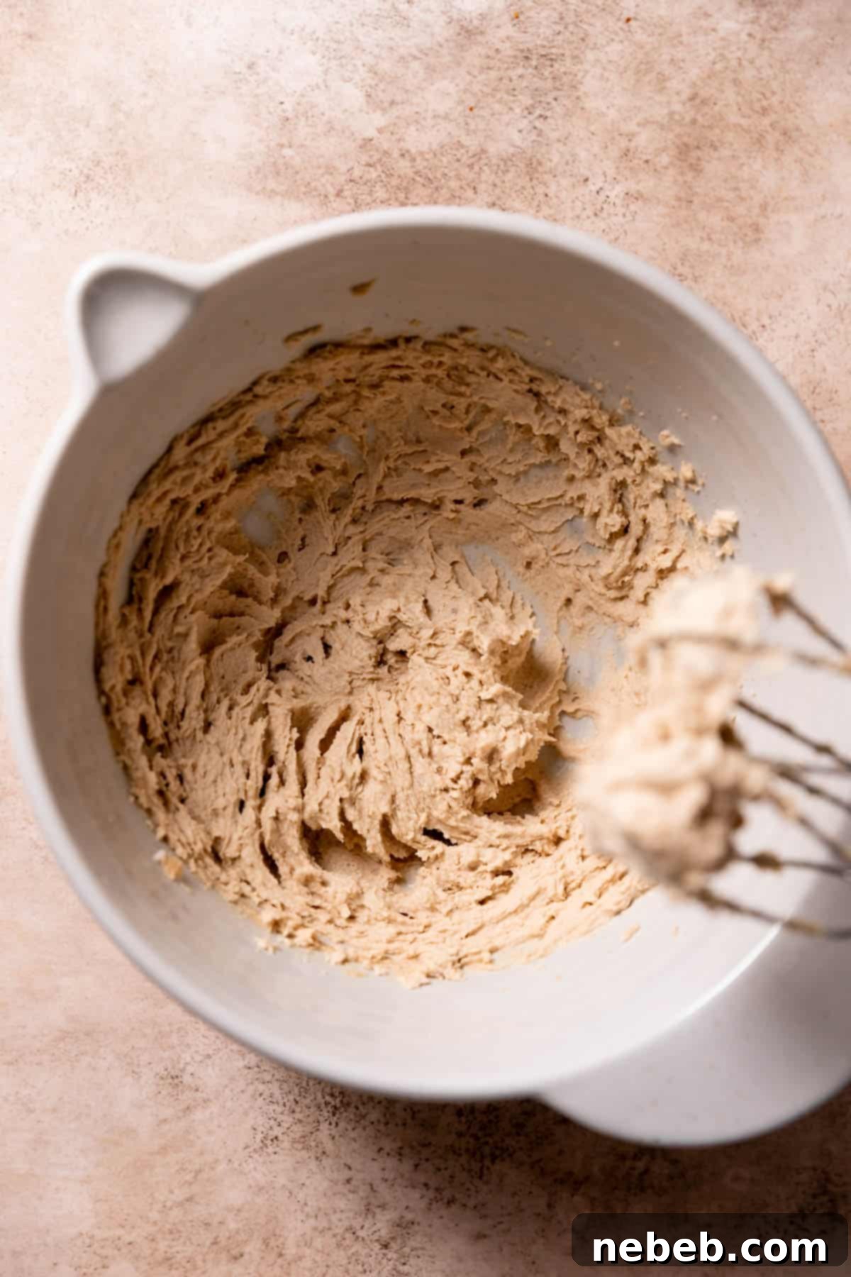 Creamed butter and brown sugar in a large mixing bowl, looking light and fluffy.