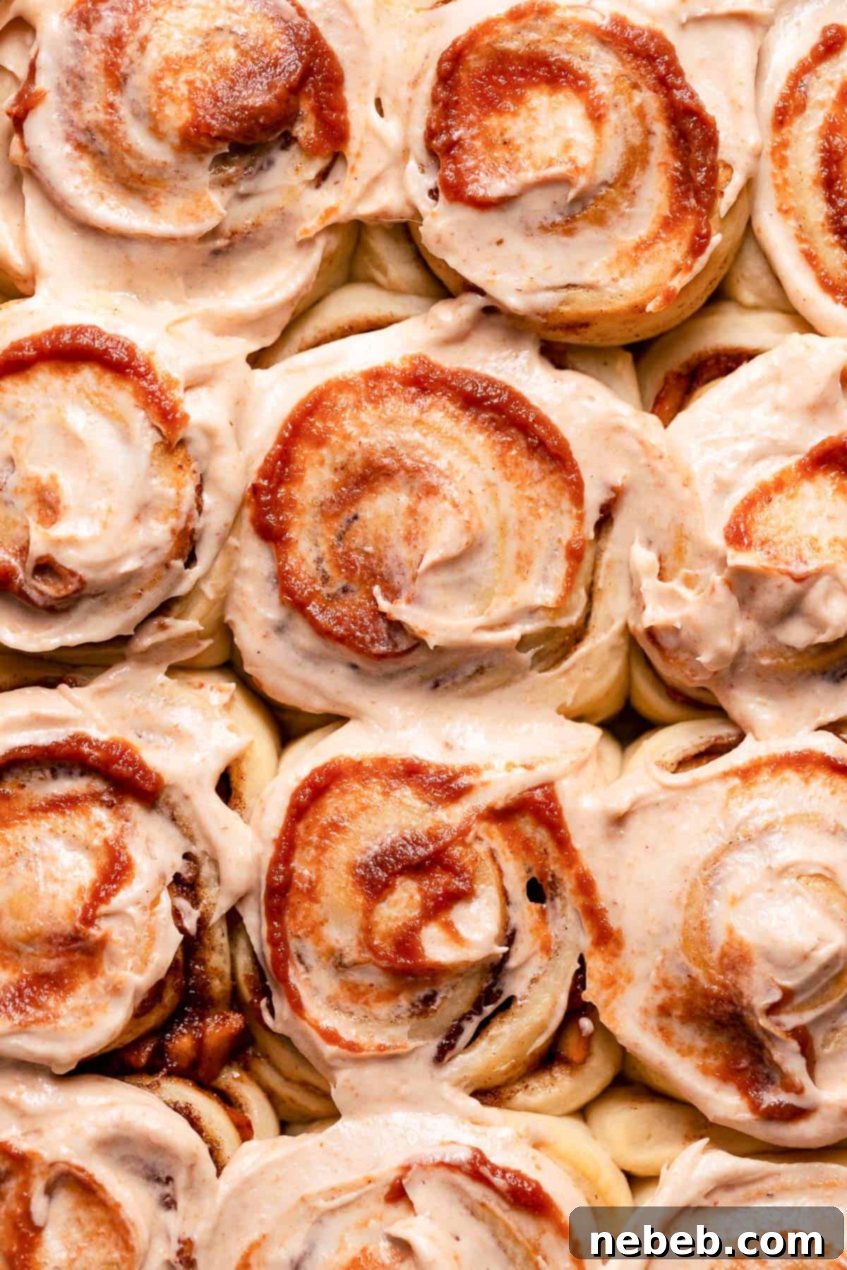 Cinnamon apple rolls with cream cheese frosting and a swirl of apple butter.