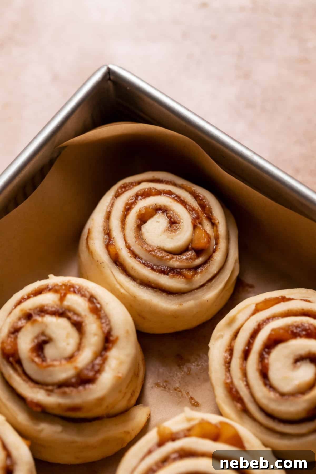 Apple cinnamon rolls in a baking pan before baking.