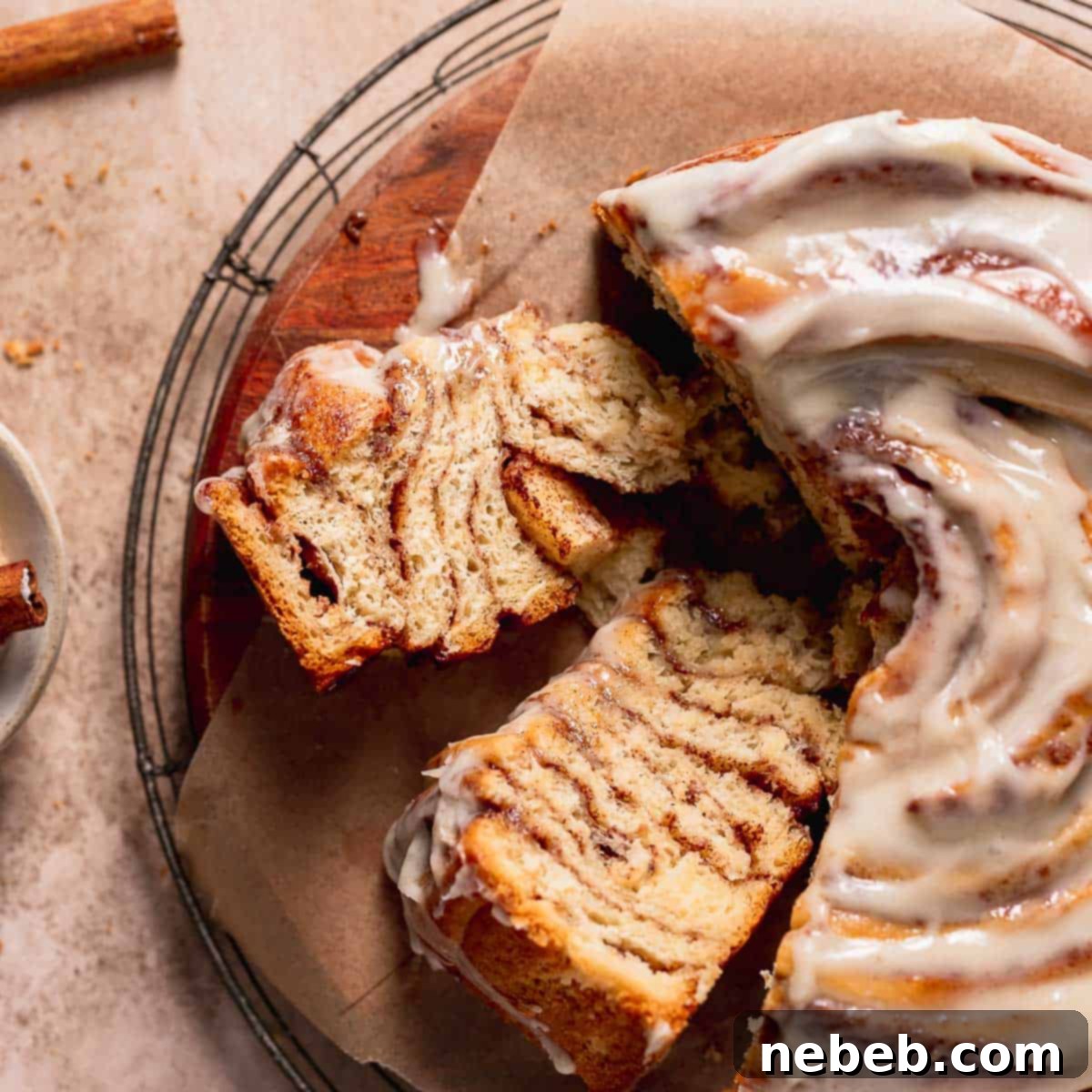 Cinnamon roll cake slices on a wooden platter on their sides to show the cinnamon swirl texture.