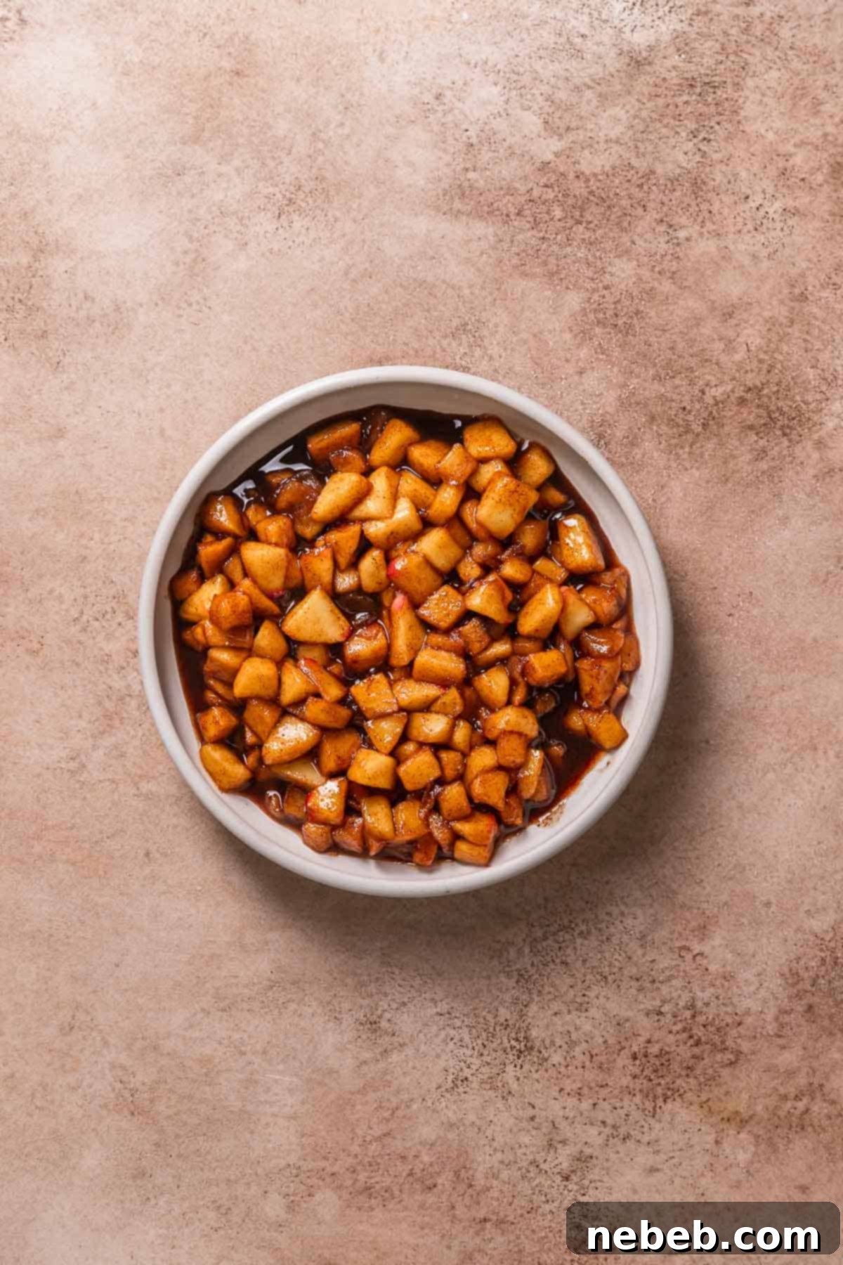 Apple pie filling in a white bowl.