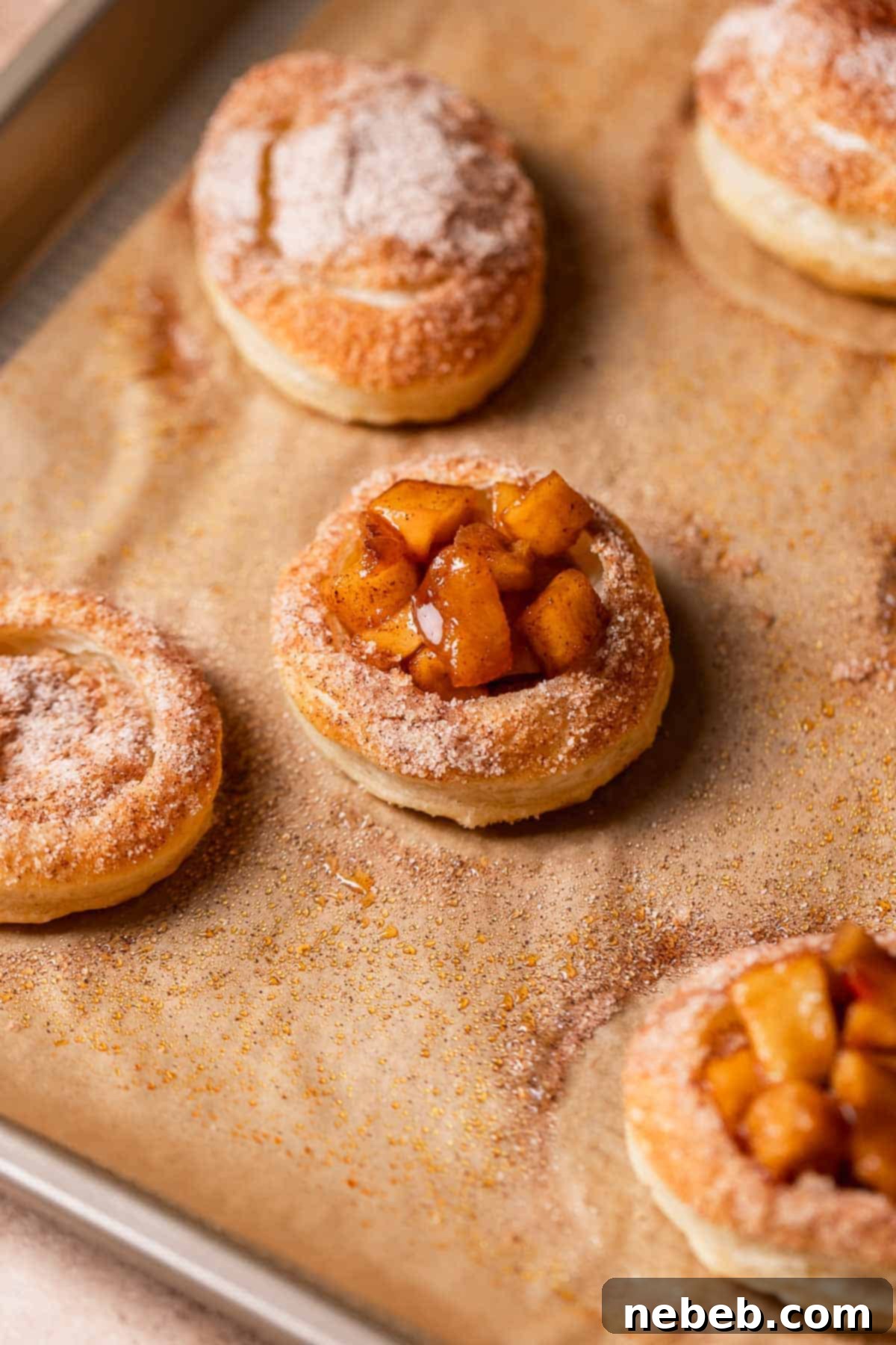Pie filled cookies on a baking sheet after baking.