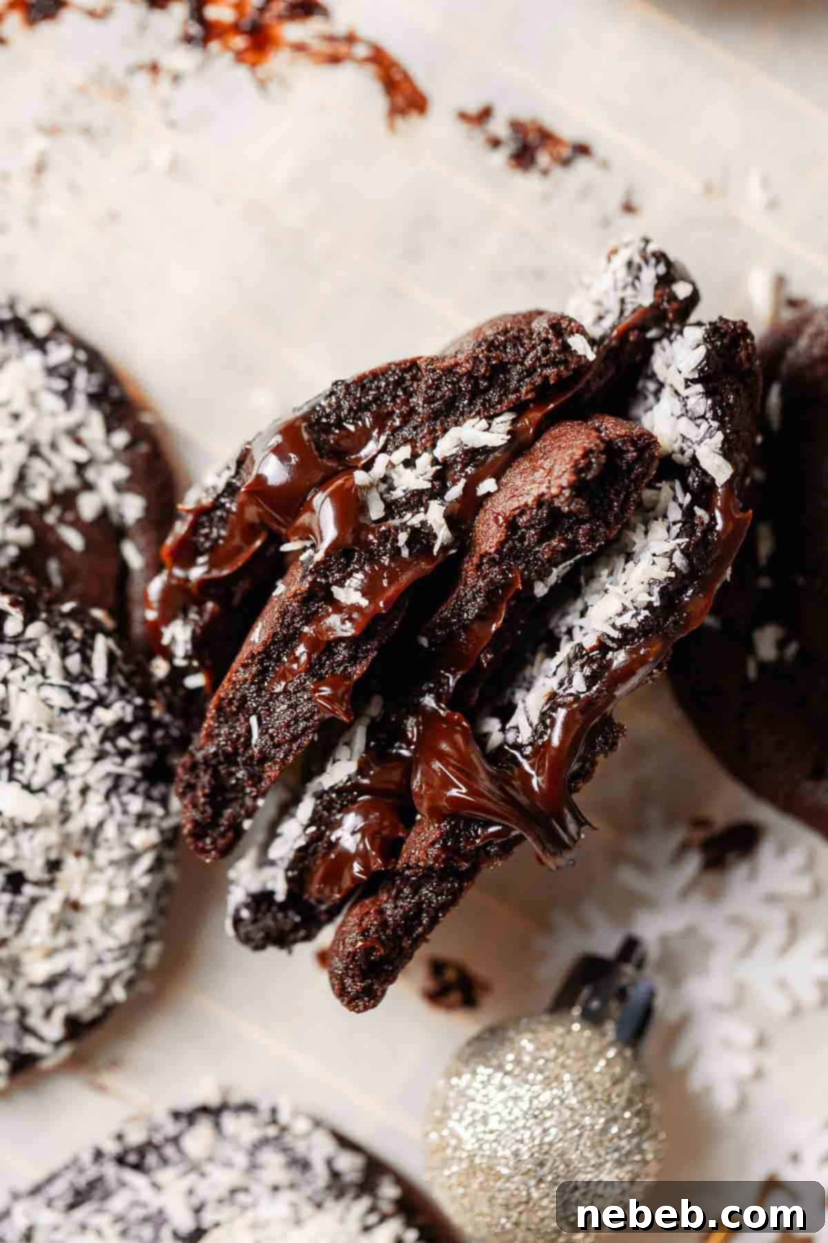 Chocolate fudge lamington cookies cut in half to show the fudge filling.