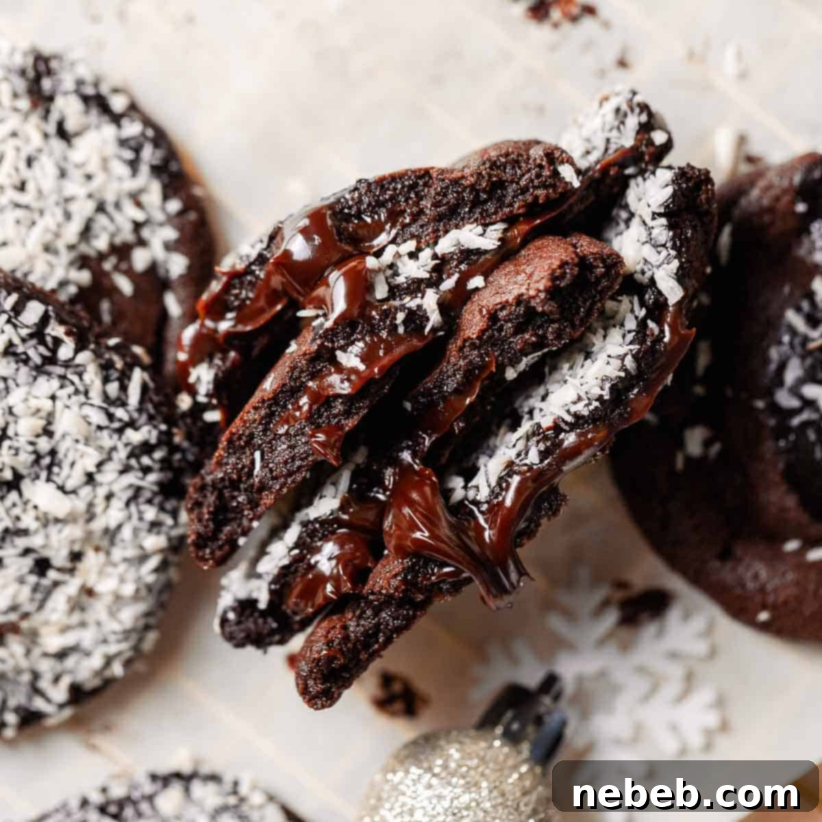 A stack of chocolate cookies on their sides broken in half to show the gooey hot fudge center.
