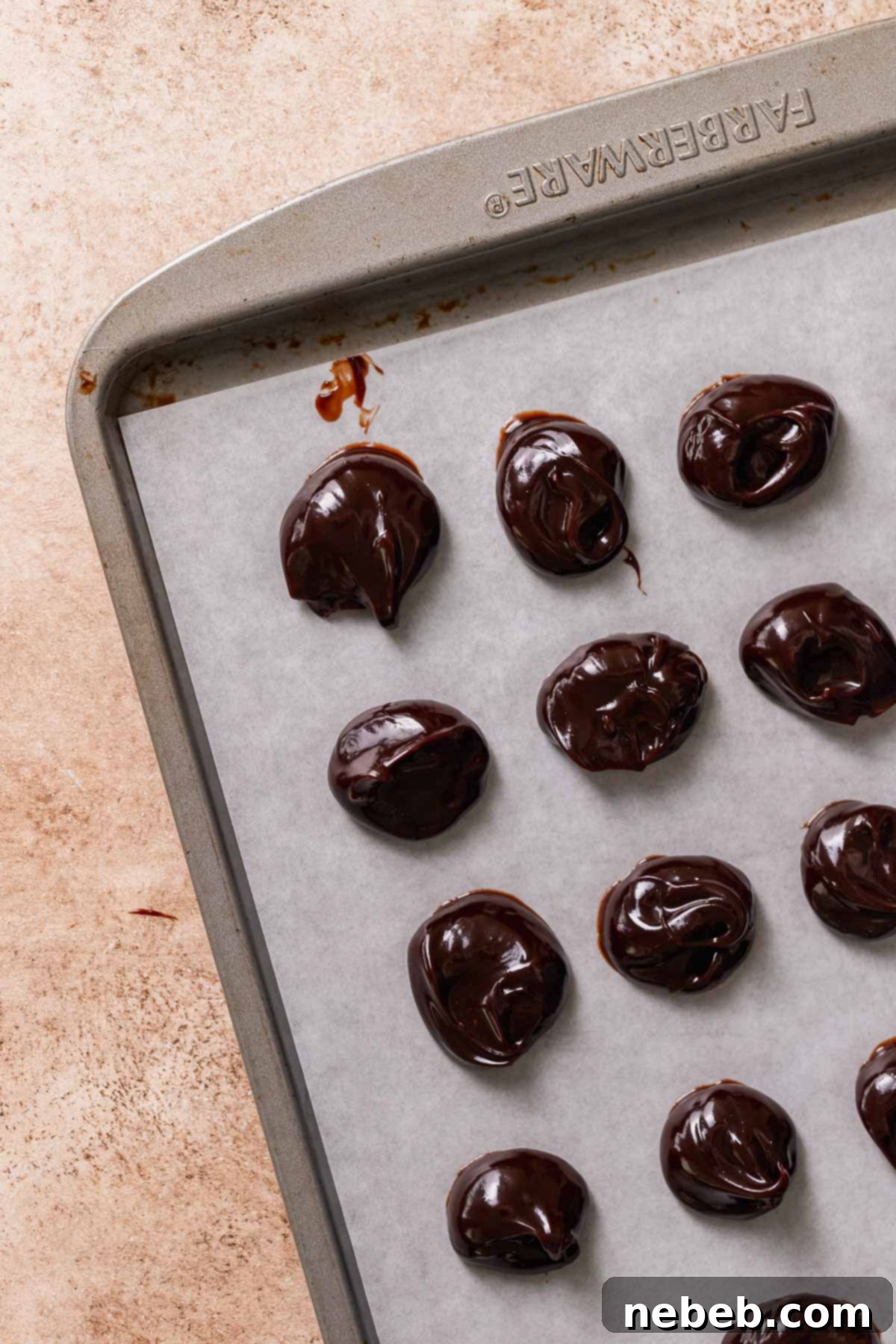A baking sheet with dollops of chocolate fudge.