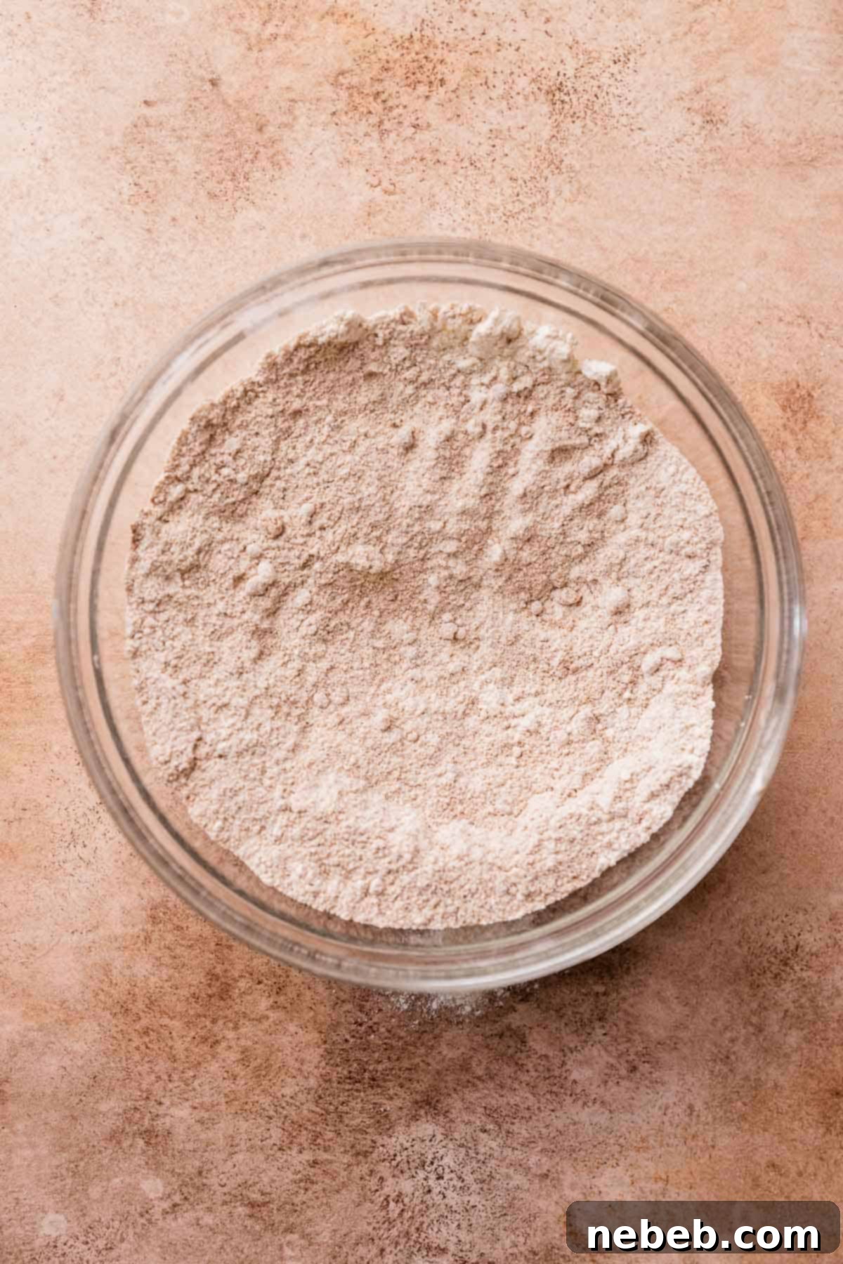 A glass mixing bowl with the whisked dry ingredients.
