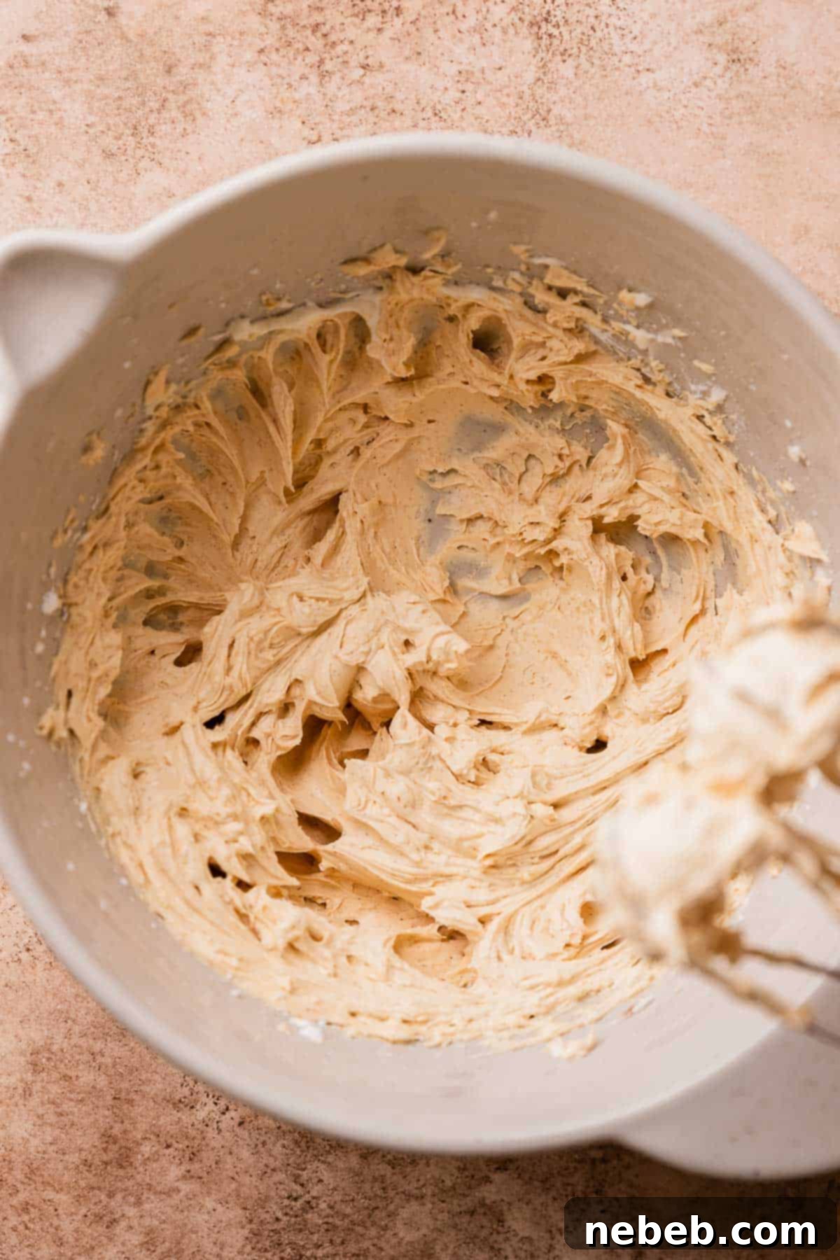 A mixing bowl with the cinnamon molasses buttercream frosting.
