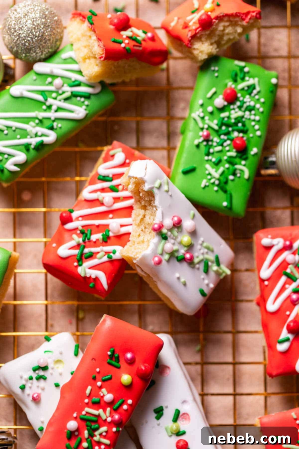 Christmas sugar cookie bars with festive sprinkles on a gold wire rack.