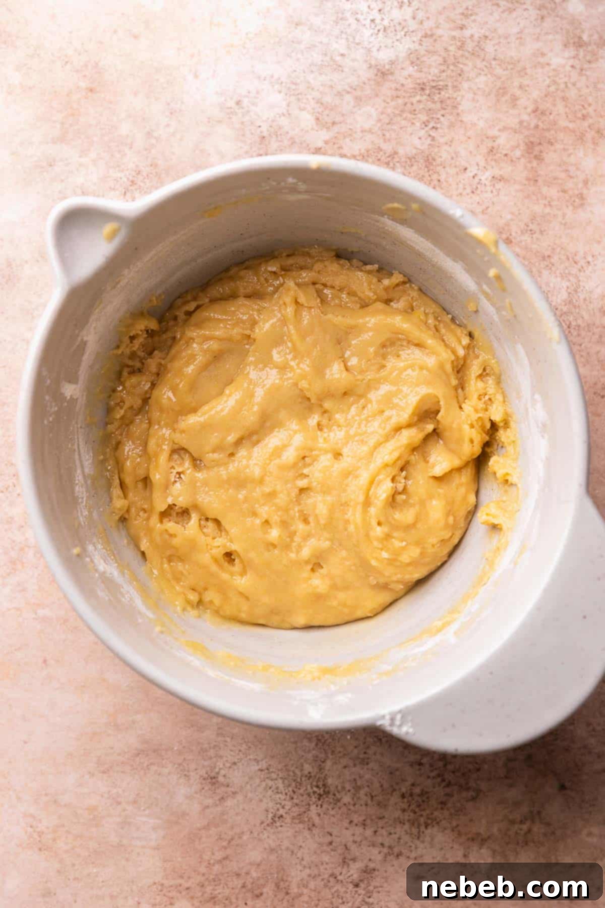 A mixing bowl with the sugar cookie dough inside it.