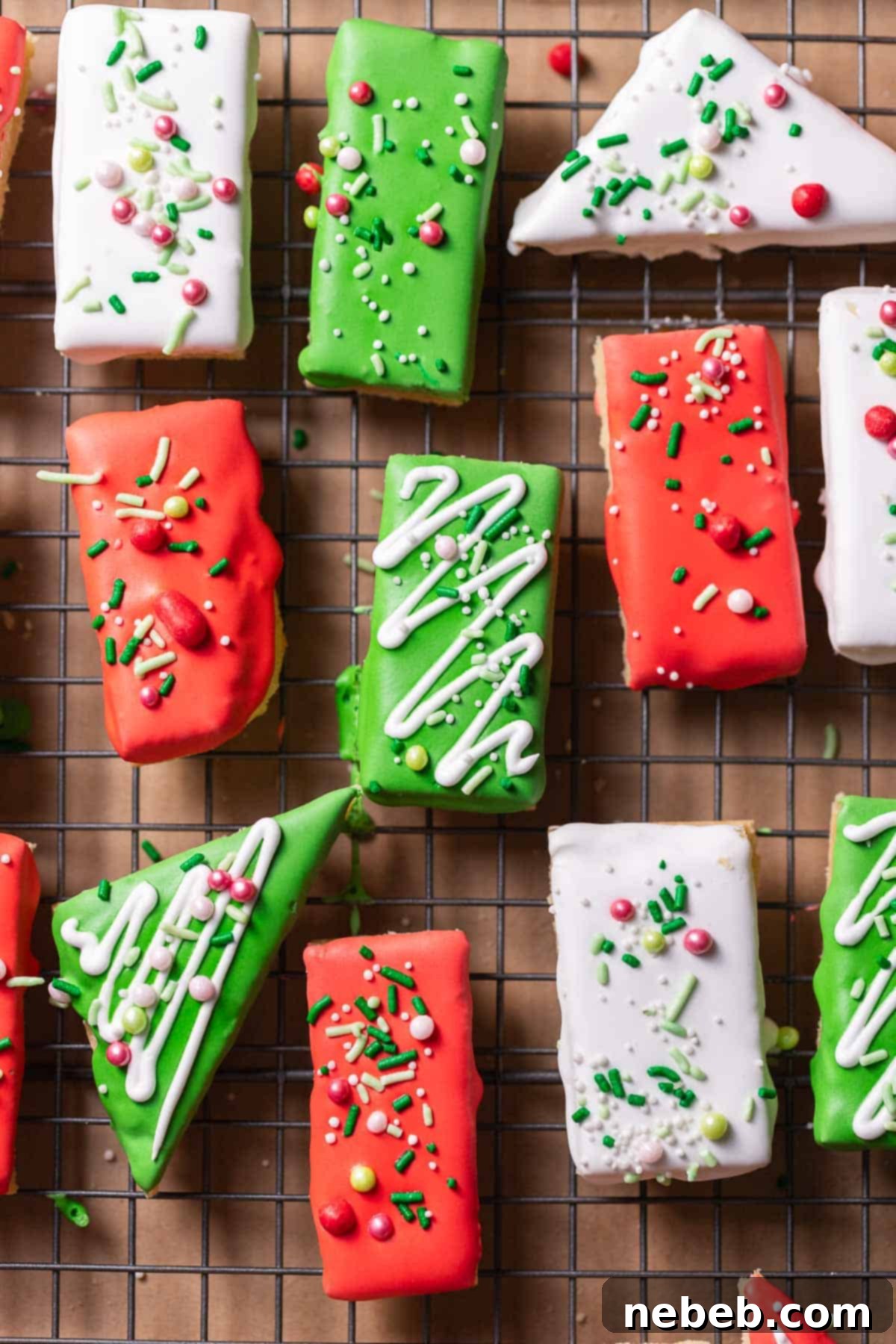 Decorated sugar cookie bars covered in frosting and sprinkles on a wire rack.
