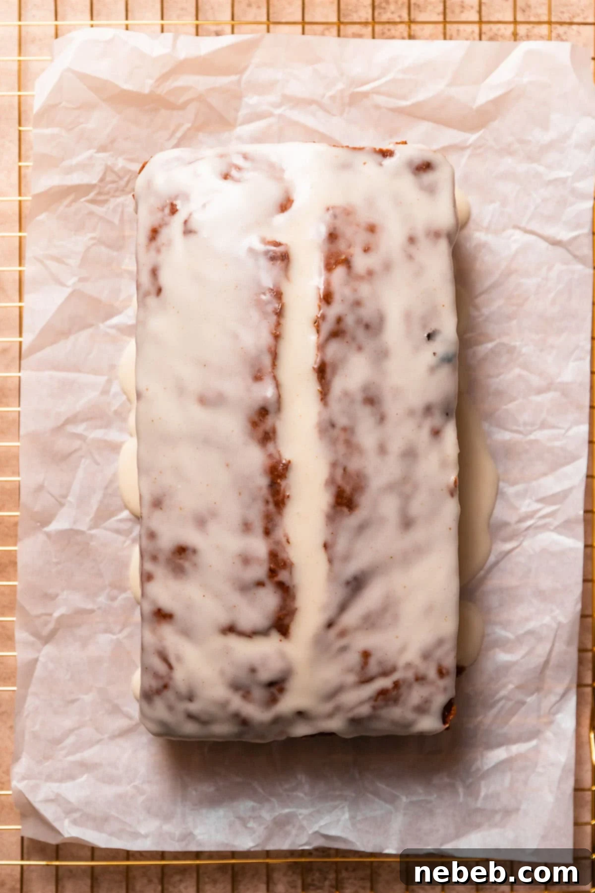 The glazed brown butter banana bread loaf on parchment paper.