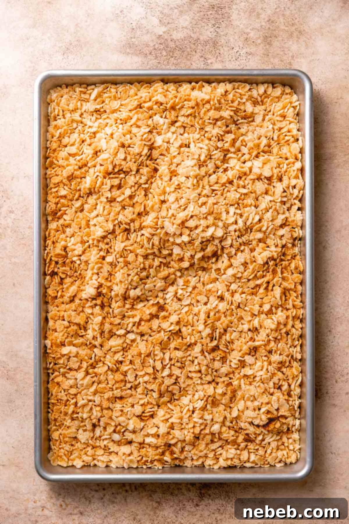 A baking pan with the golden brown crispy rice cereal on it.