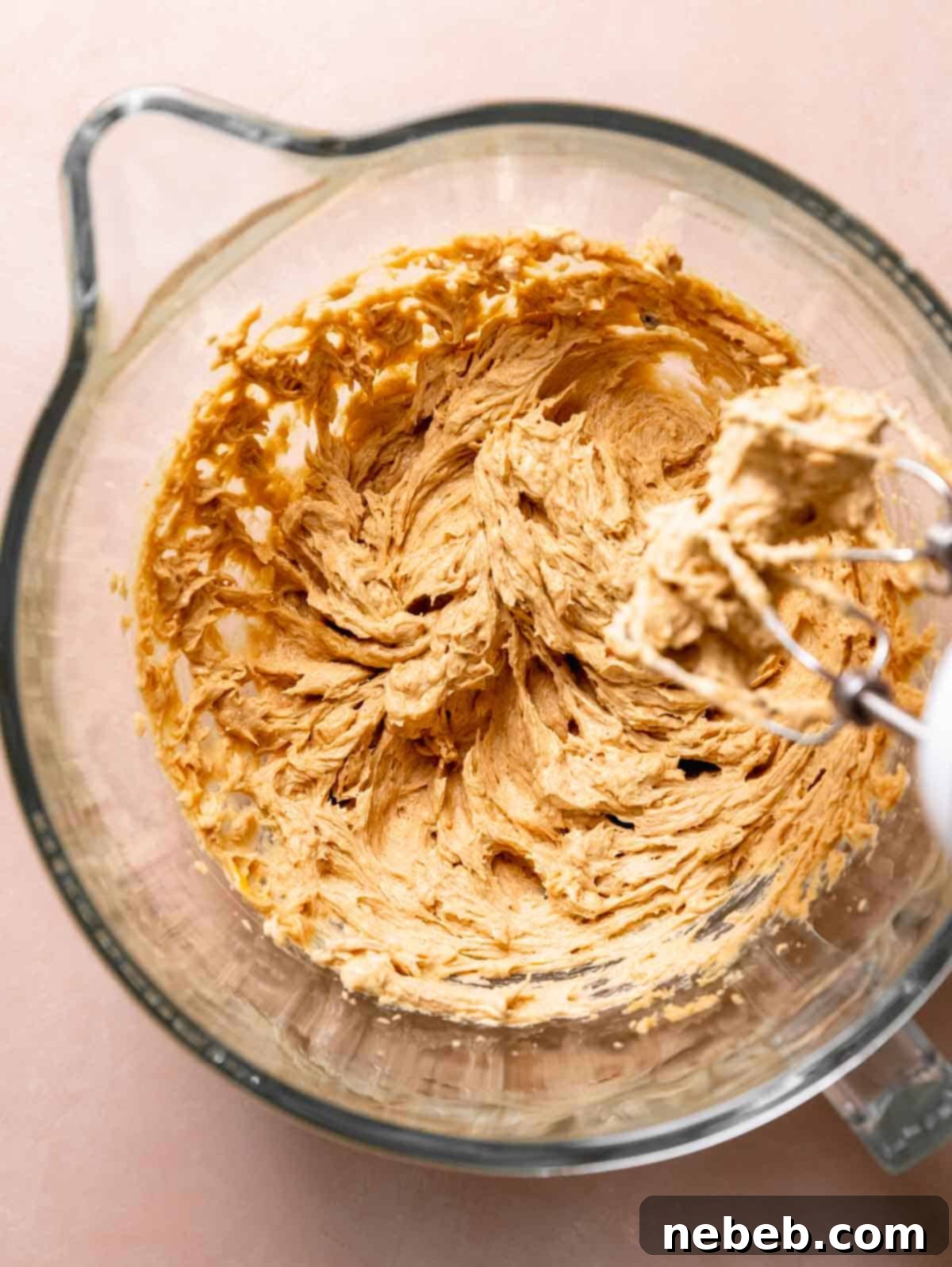 A glass mixing bowl with the cookie dough after mixing in the egg and vanilla bean paste.