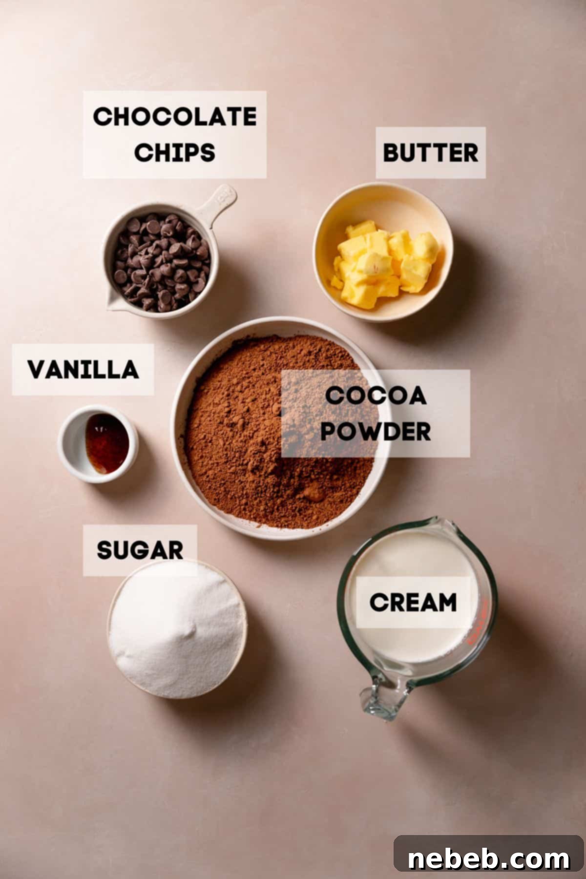 Ingredients needed to make homemade fudge frosting in bowls with labels.