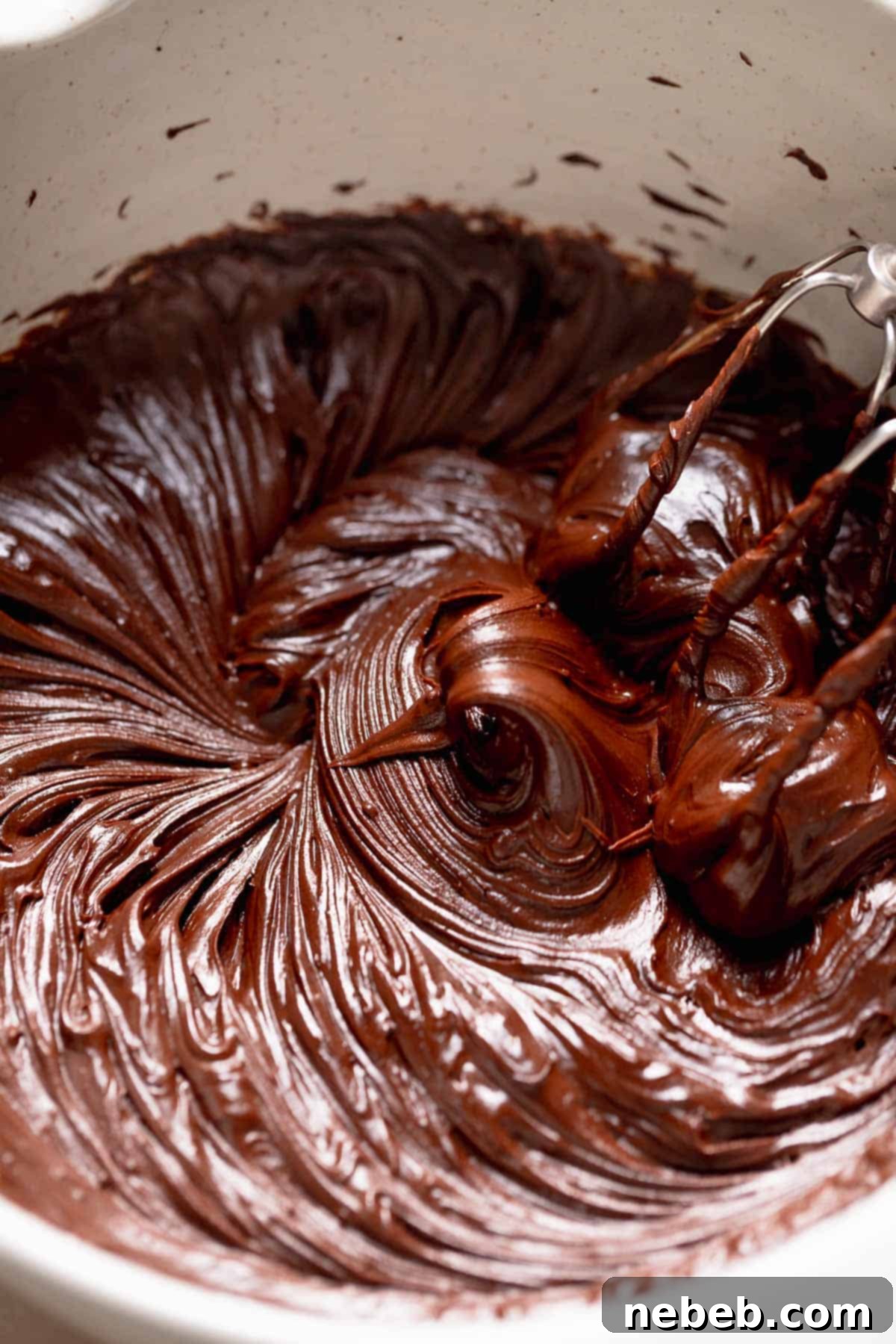 A mixing bowl with the chocolate fudge frosting after beating.