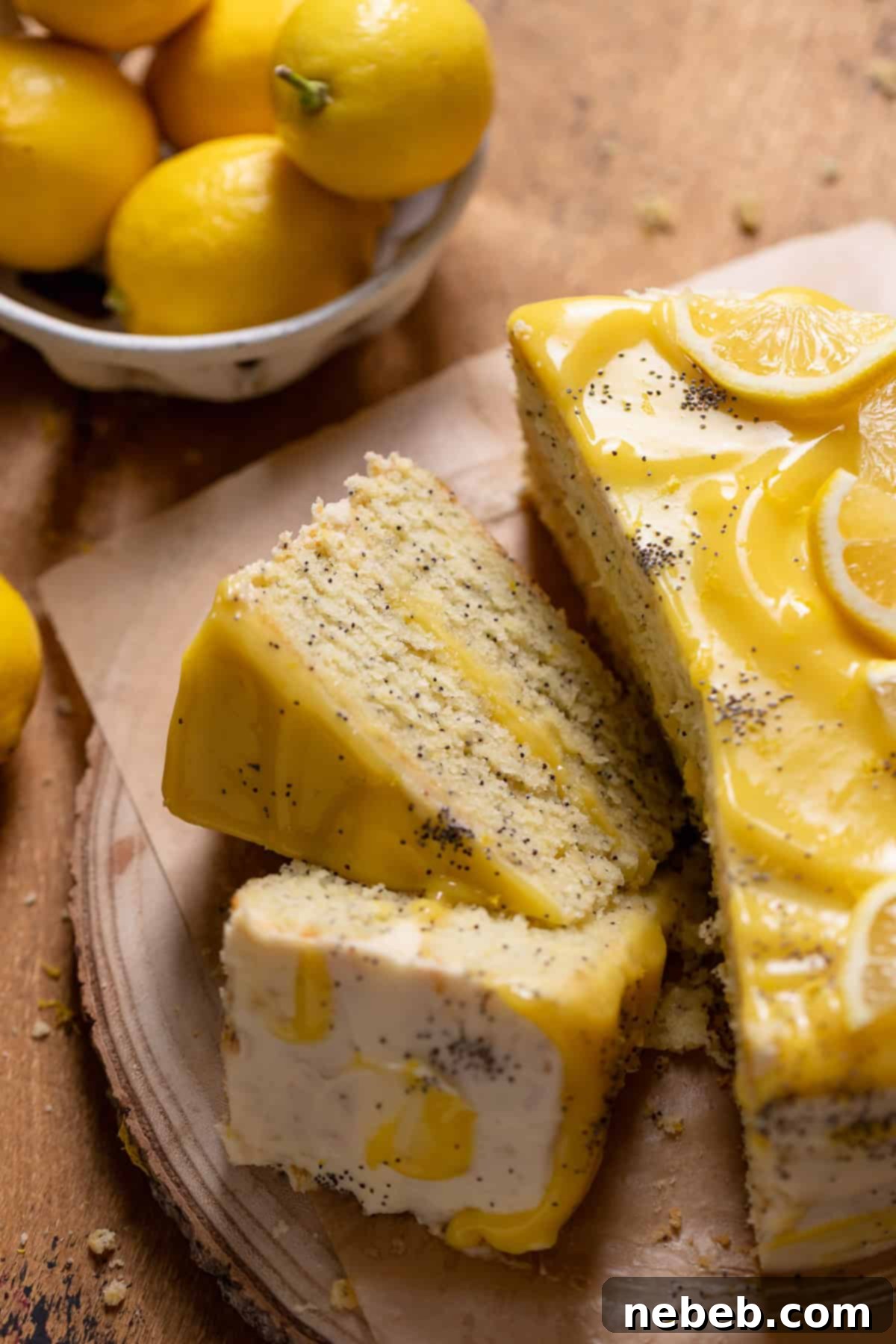 Slices of lemon poppy seed cake on a wooden backdrop.