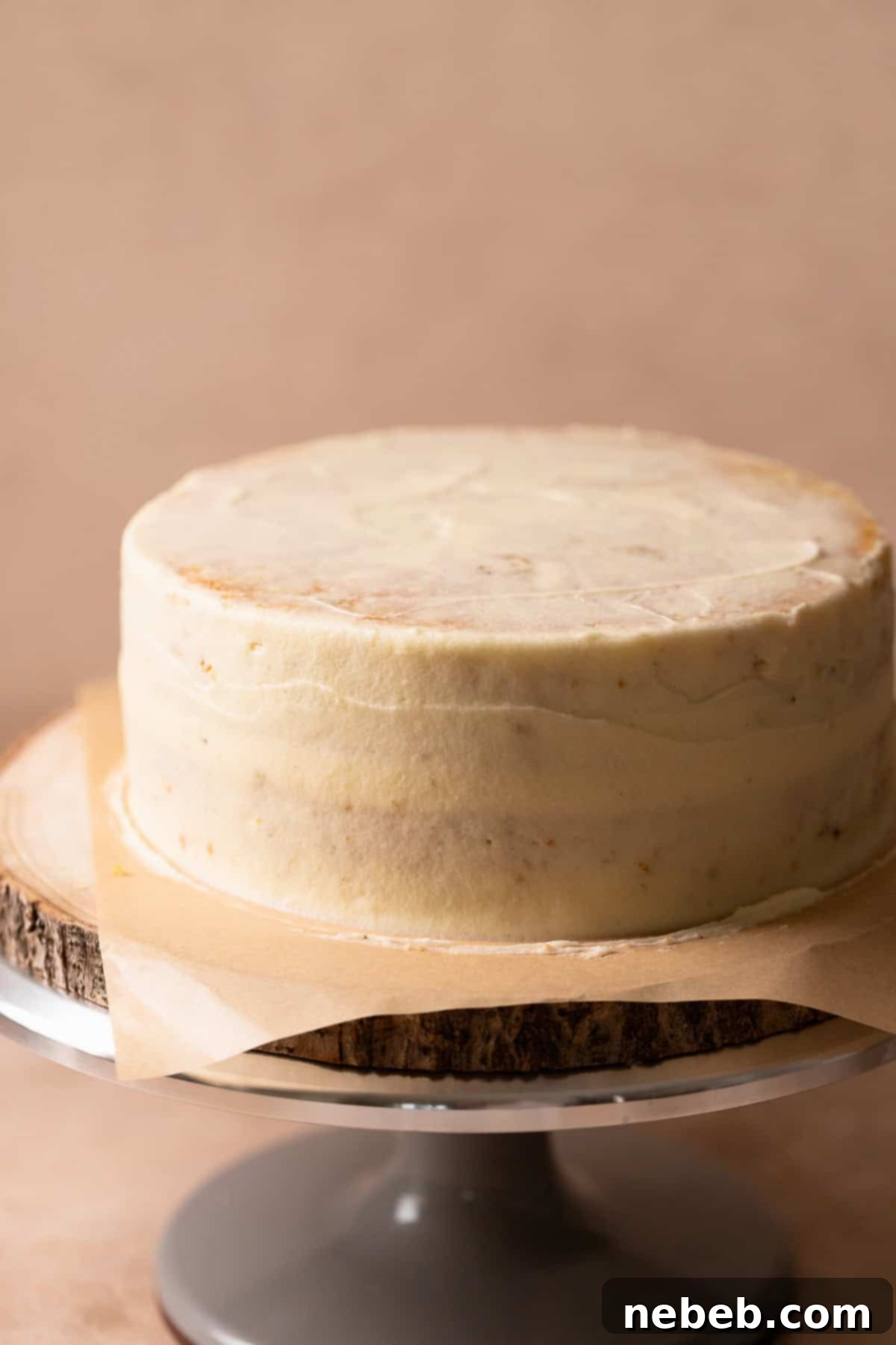 Lemon cake with a thin layer of cream cheese frosting covering it.