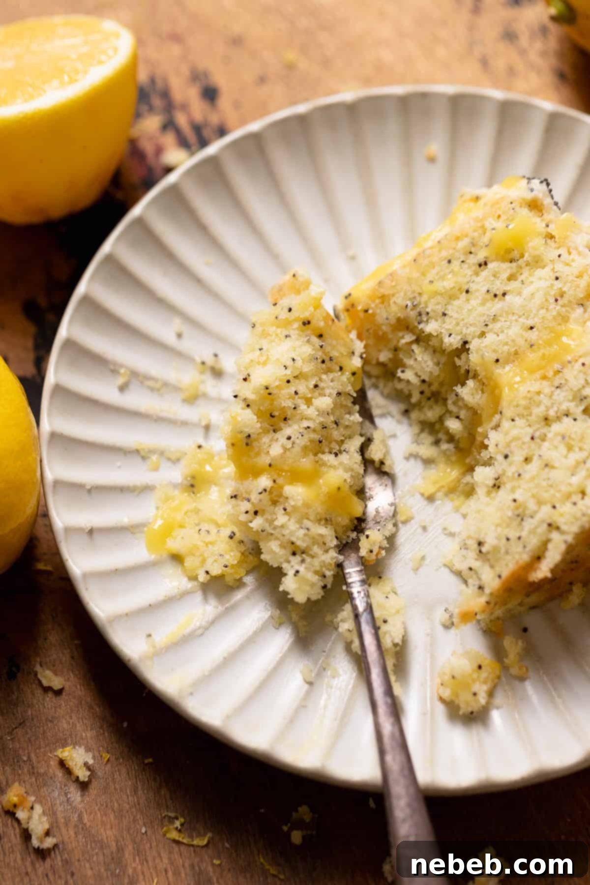 A bite of lemon poppy cake on a fork.