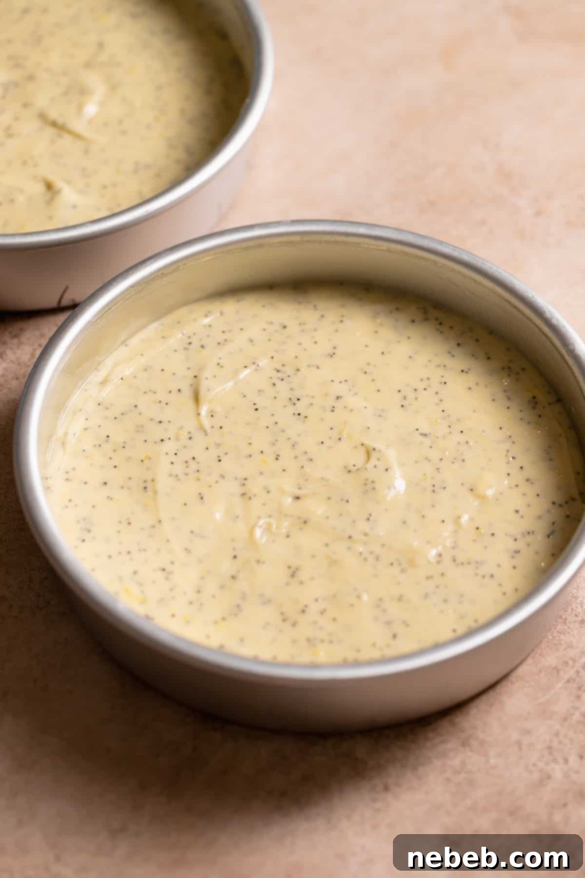 Cake pans full of lemon cake batter before baking.