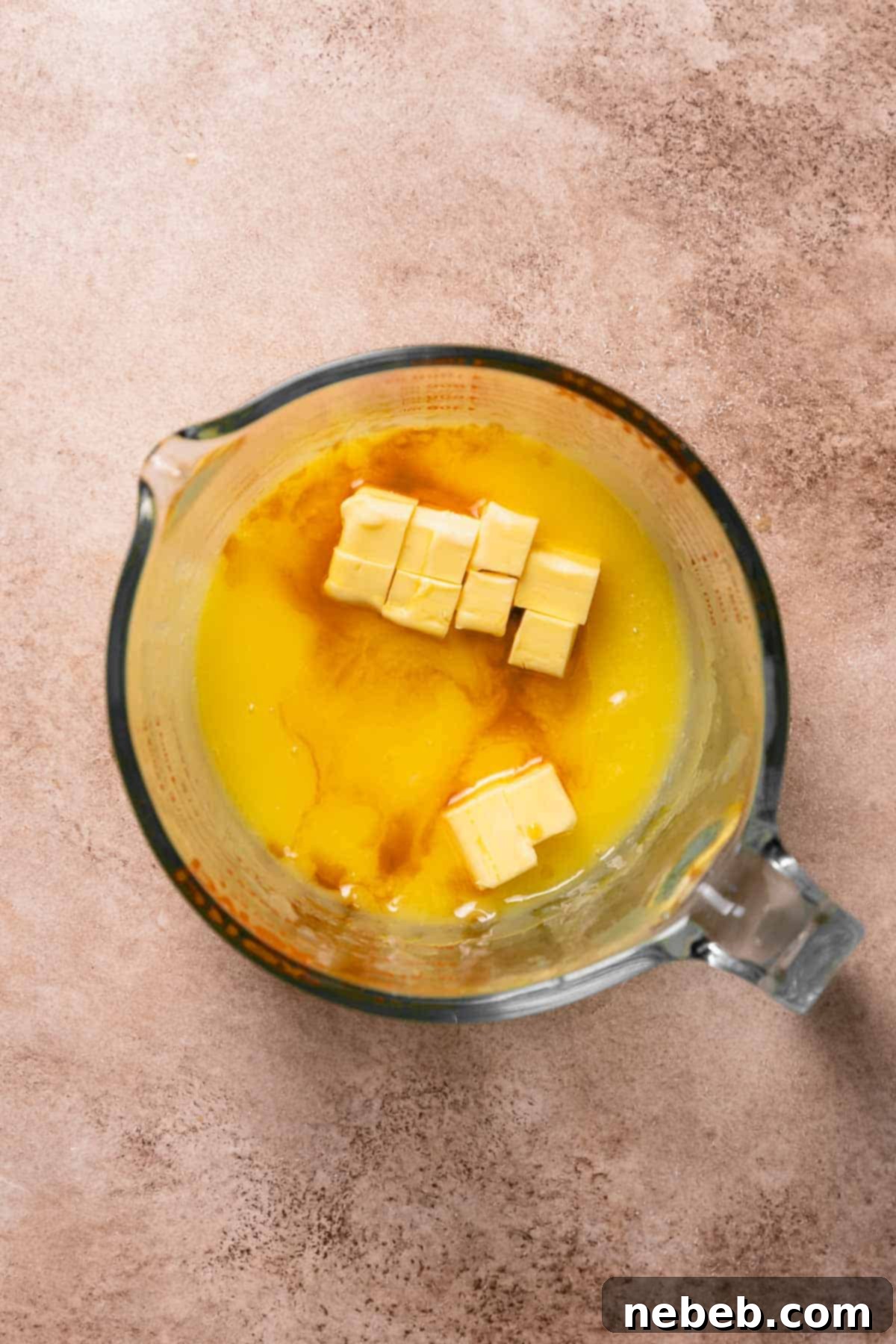 A glass bowl with the cooked and strained lemon curd, ready for the final additions of butter and vanilla.