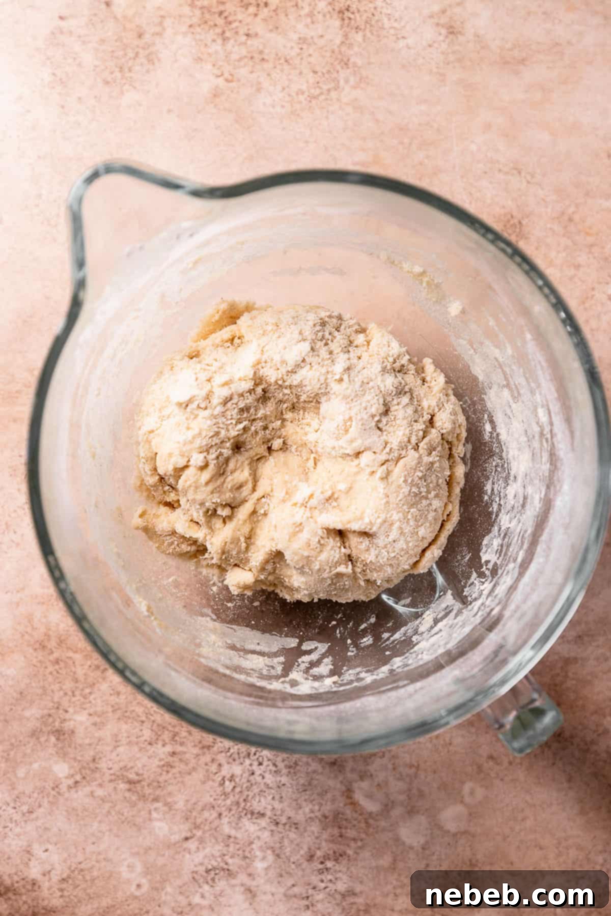 A rough dough ball in a mixing bowl, prior to full kneading.