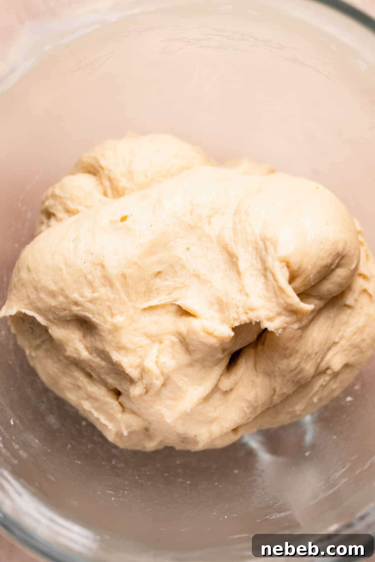 The soft and smooth dough ball in a mixing bowl after kneading.