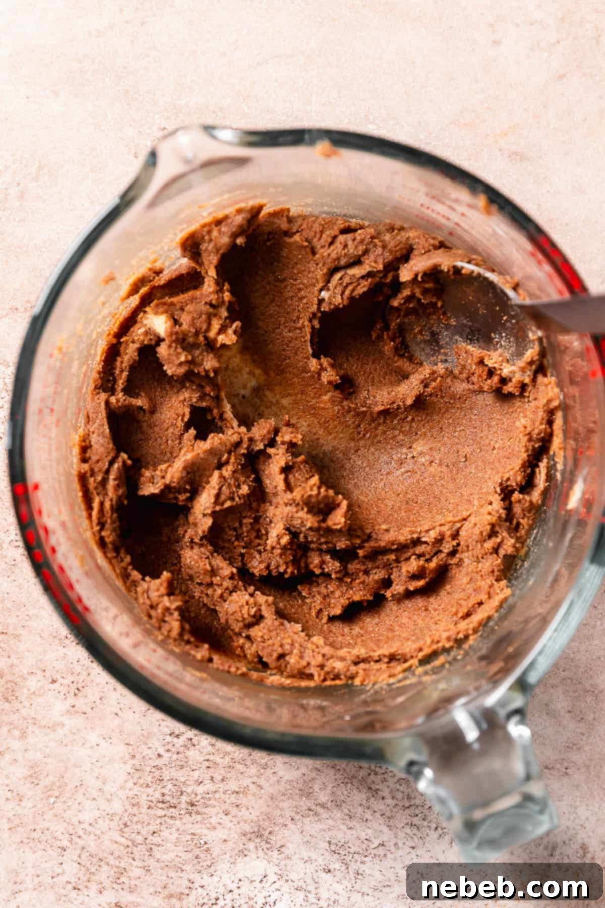 Brown sugar cinnamon filling mixed together in a glass bowl, ready for spreading.