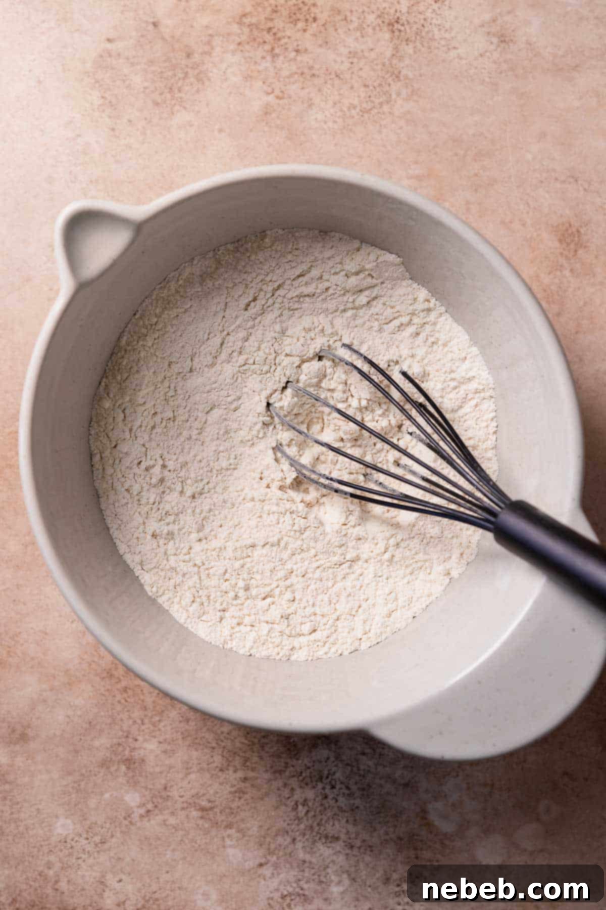 A mixing bowl with the whisked dry ingredients for the muffin batter, ready for the wet ingredients.