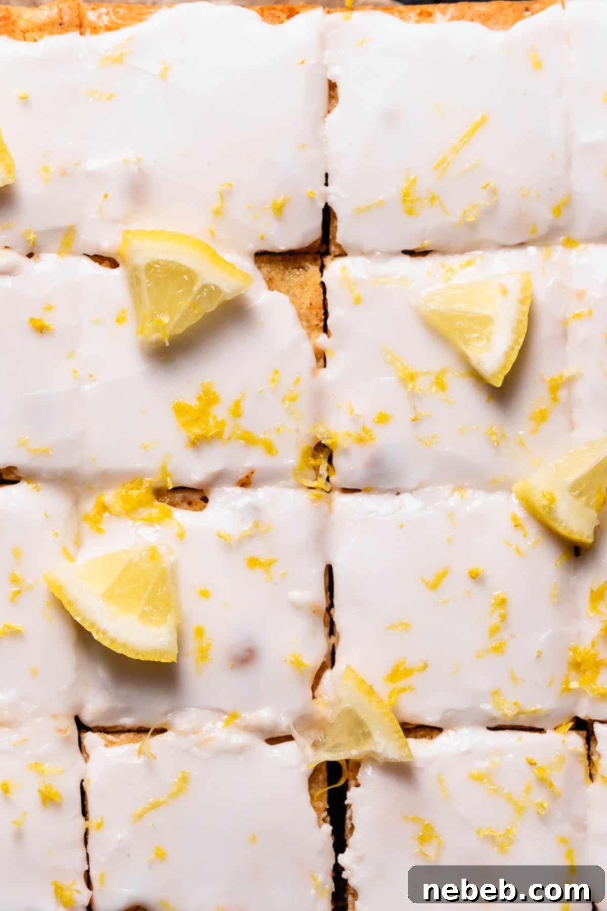 Freshly baked lemon brownies, beautifully glazed with a sweet lemon icing and garnished with lemon zest.