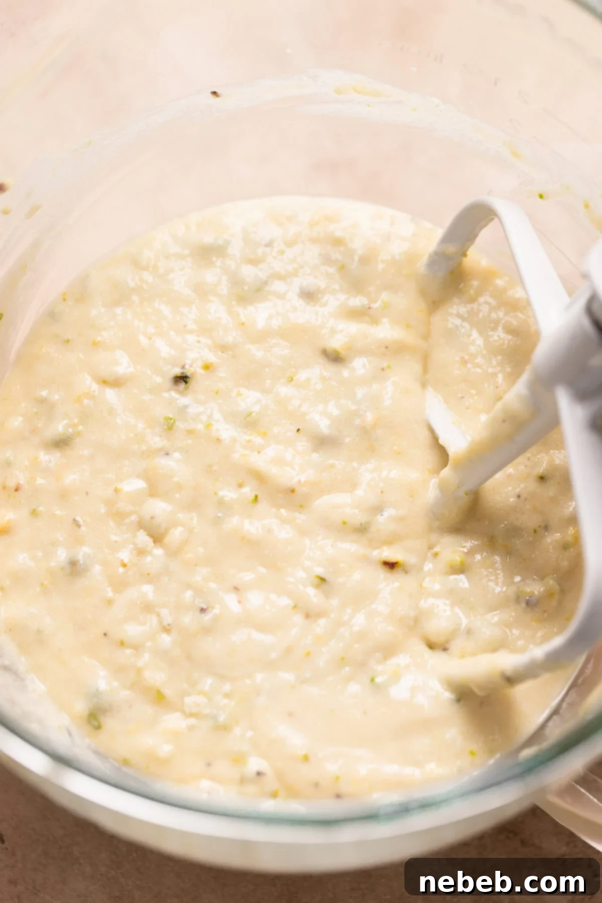Smooth, pale yellow lemon cupcake batter in a mixing bowl, ready for baking.