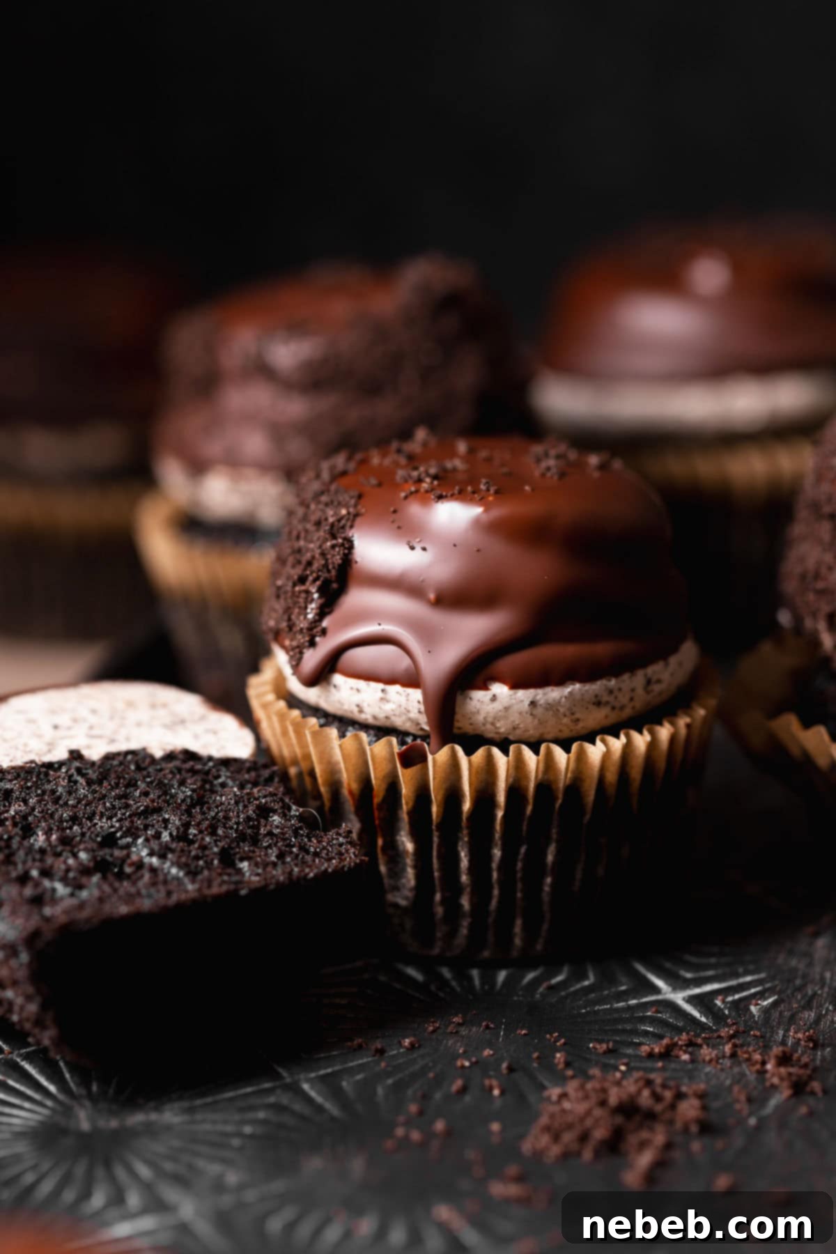 Collection of Hi-Hat Oreo Cupcakes neatly arranged on a black baking sheet.