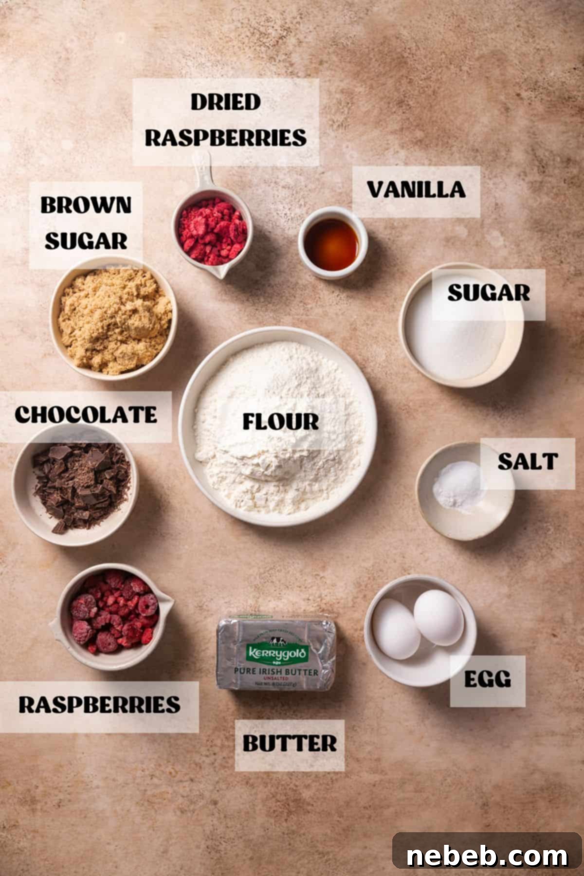 Ingredients needed to make dark chocolate raspberry cookies in bowls with labels.