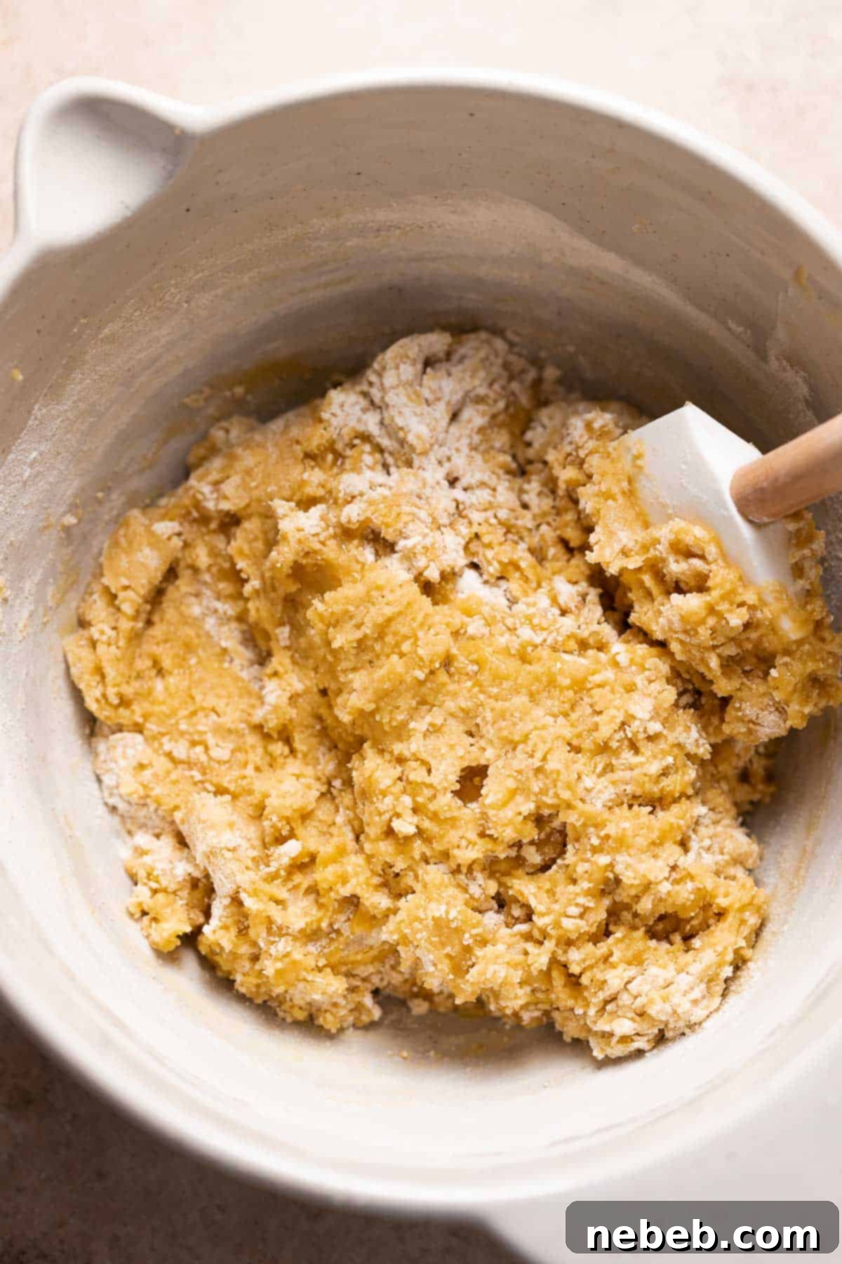 A mixing bowl with the cookie dough after mixing in the dry ingredients.