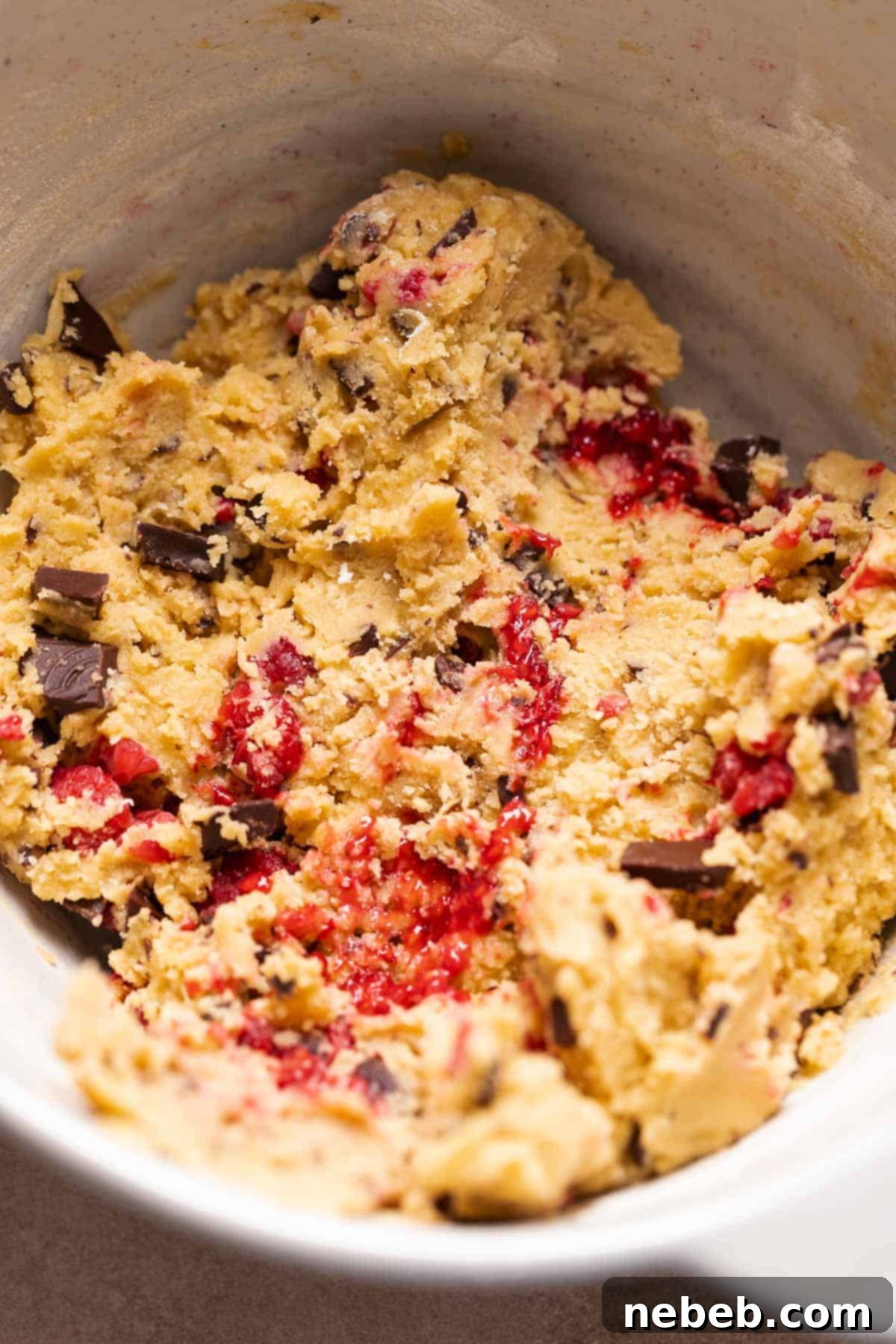 A mixing bowl with the chocolate raspberry cookie dough.