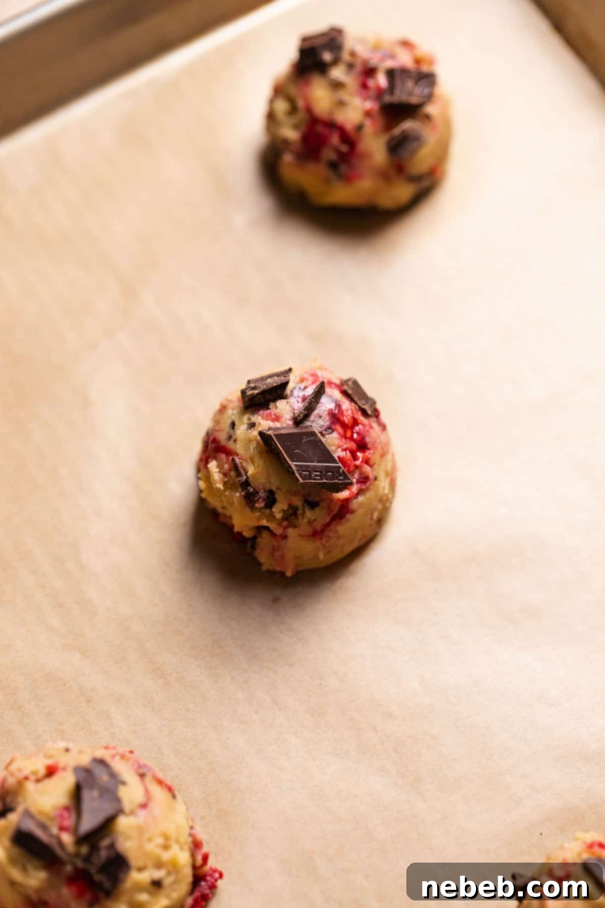 A ball of cookie dough on a baking tray before baking.