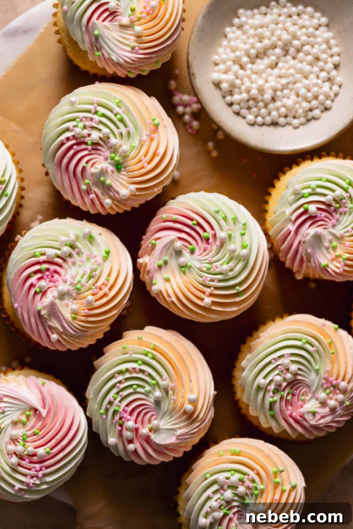 An overhead shot of the rainbow sherbet cupcakes with pearl sprinkles on top, showcasing their vibrant colors and festive appeal.