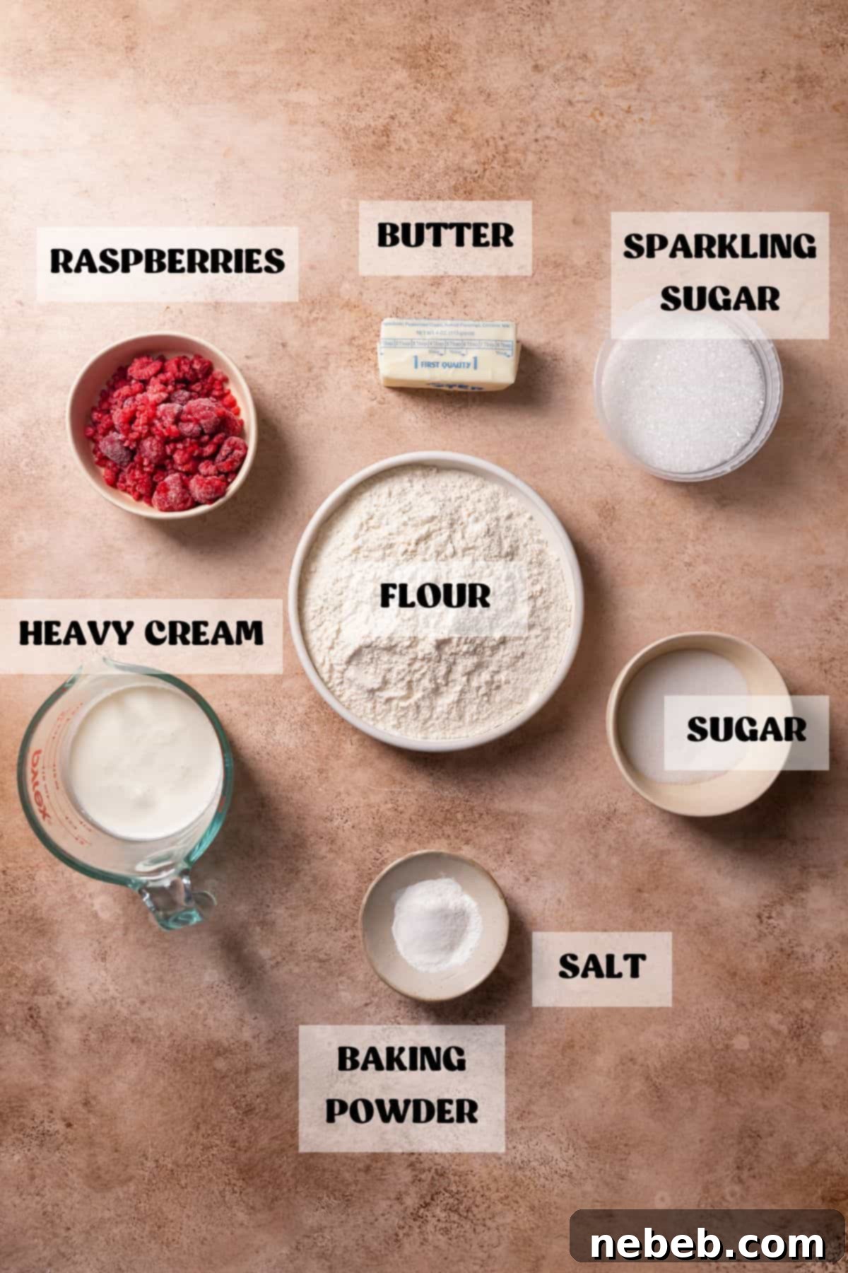 Ingredients needed to make raspberry cream scones in bowls with labels.
