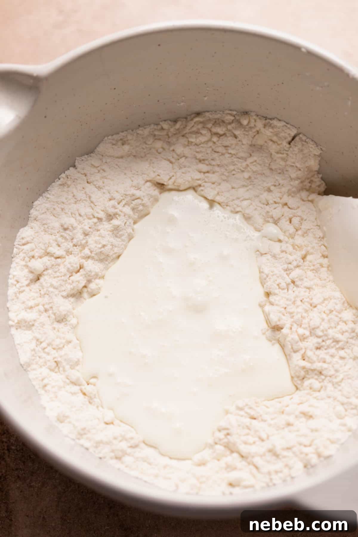 Heavy cream poured into the center of the dry ingredients before mixing.