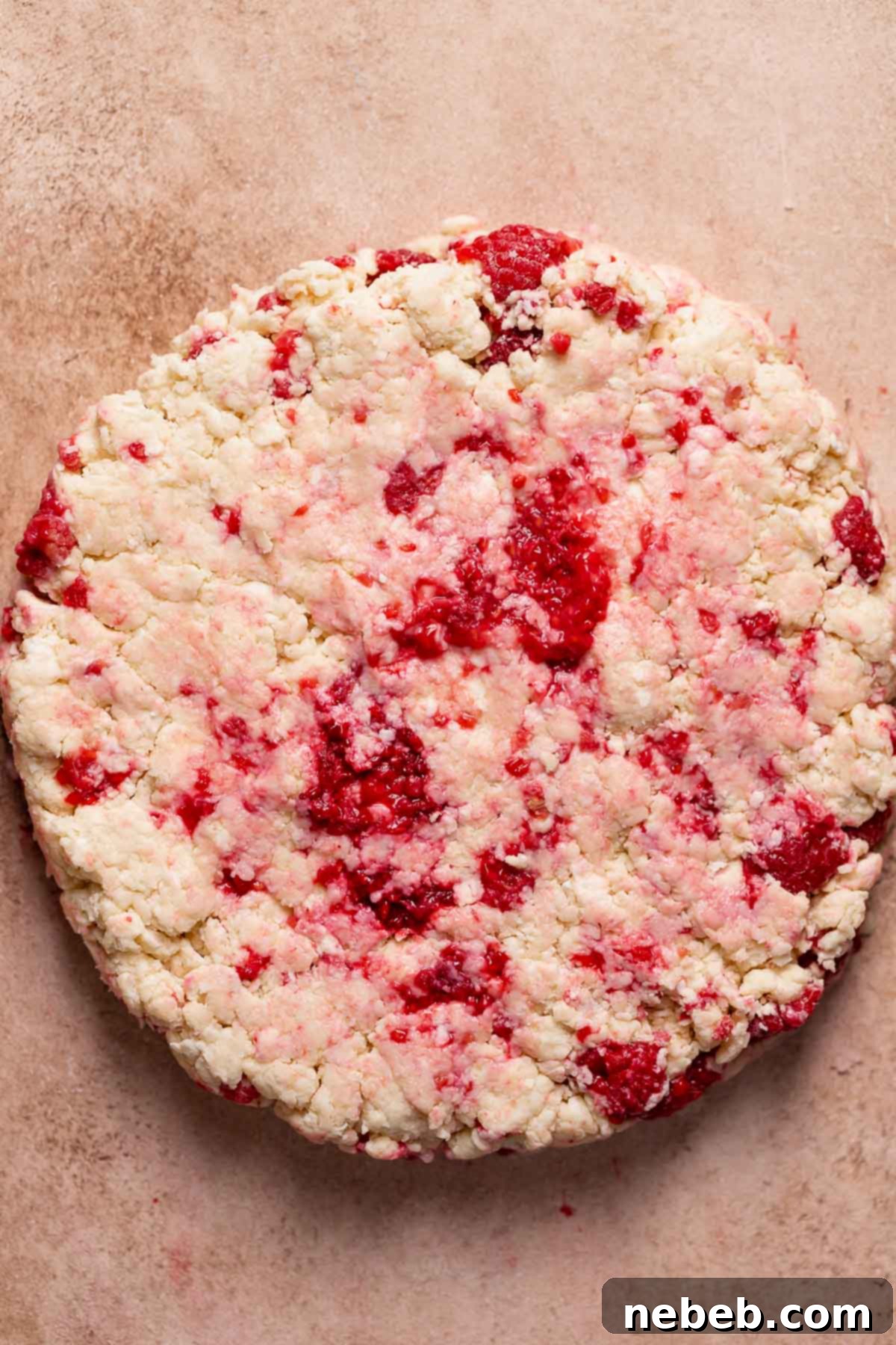 Raspberry scone dough formed into a round before cutting.
