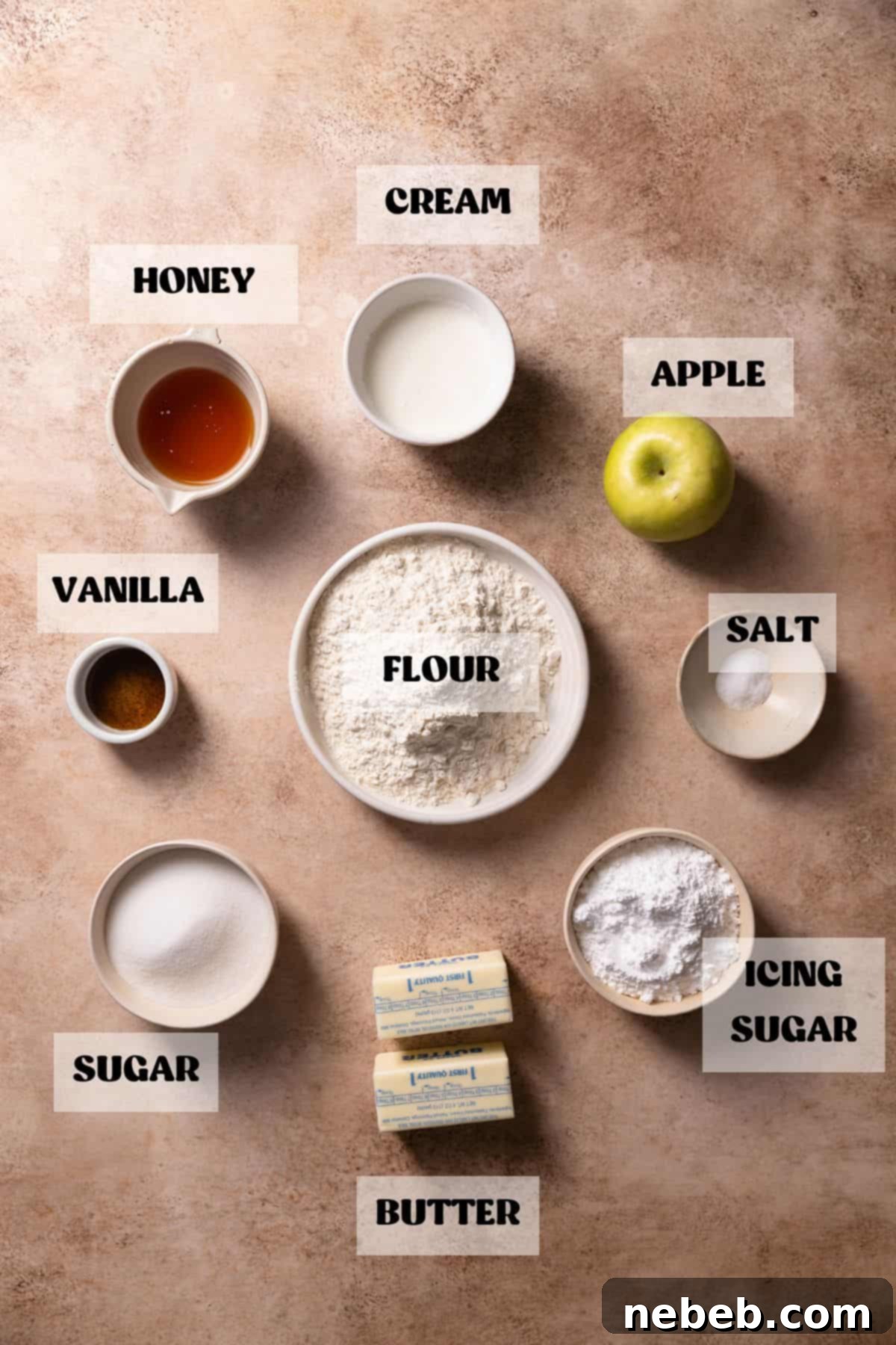 Ingredients needed to make apple caramel bars in bowls with labels, neatly arranged on a counter.