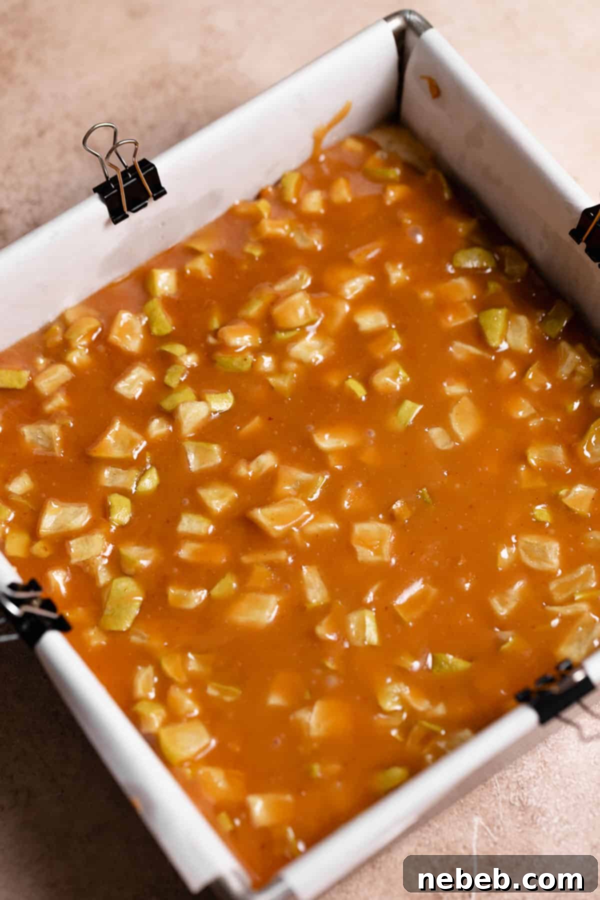 The glossy caramel apple layer freshly poured on top of the baked shortbread crust.