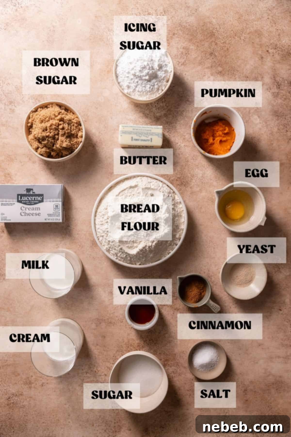 Bowls of prepped ingredients, including pumpkin puree, flour, sugar, and spices, for making pumpkin spice cinnamon rolls.