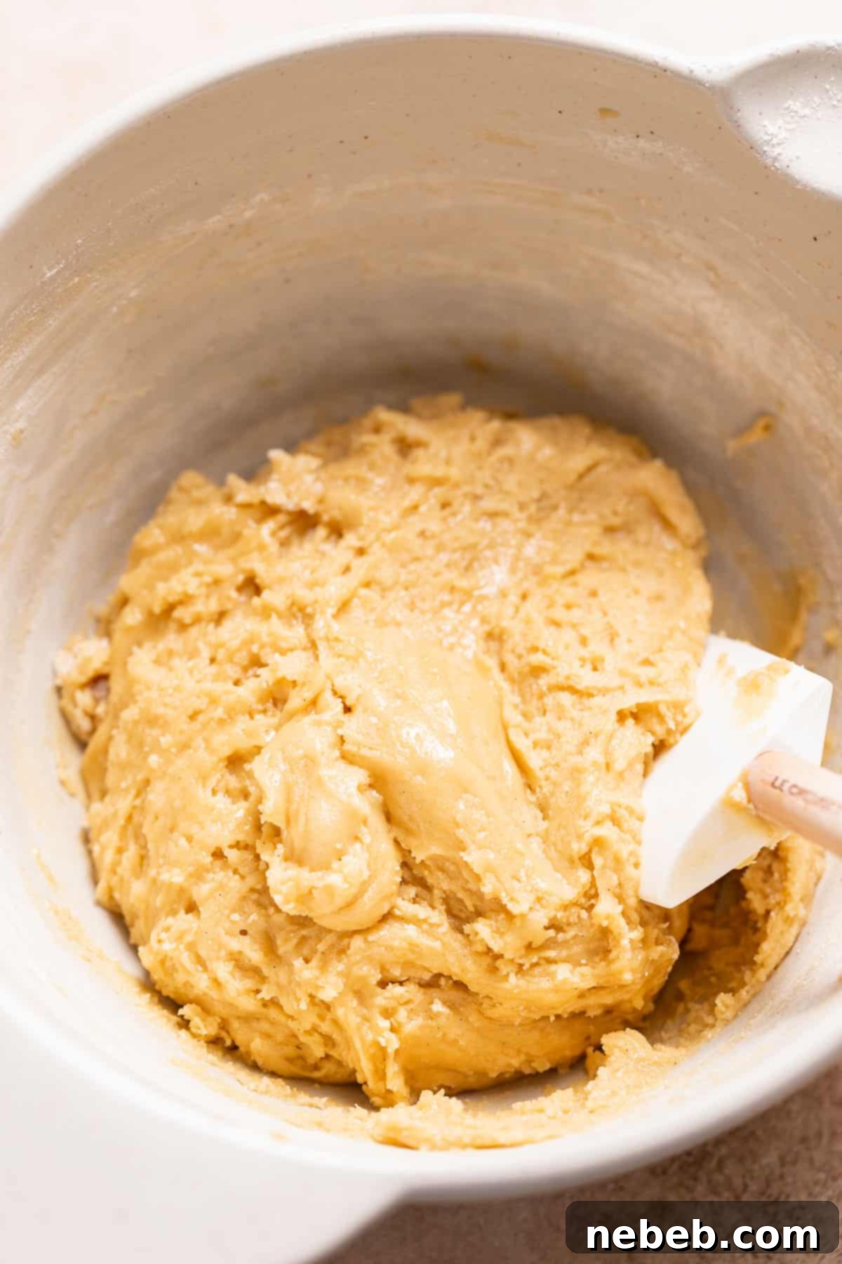 A mixing bowl filled with the finished, soft cookie dough, ready for chilling.