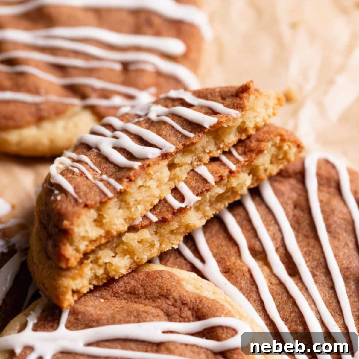 Cinnamon roll cookie broken in half to show the cinnamon sugar layer.