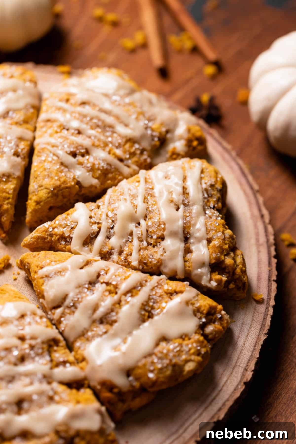 Pumpkin scones with maple glaze on a wooden board.