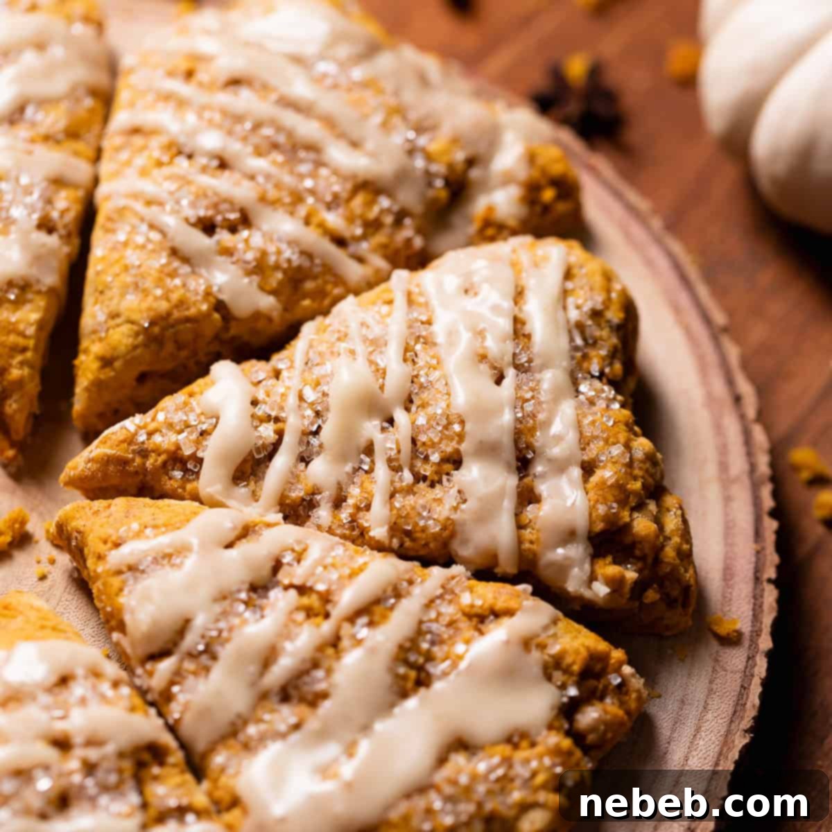 Pumpkin scones with maple glaze on a wooden board.